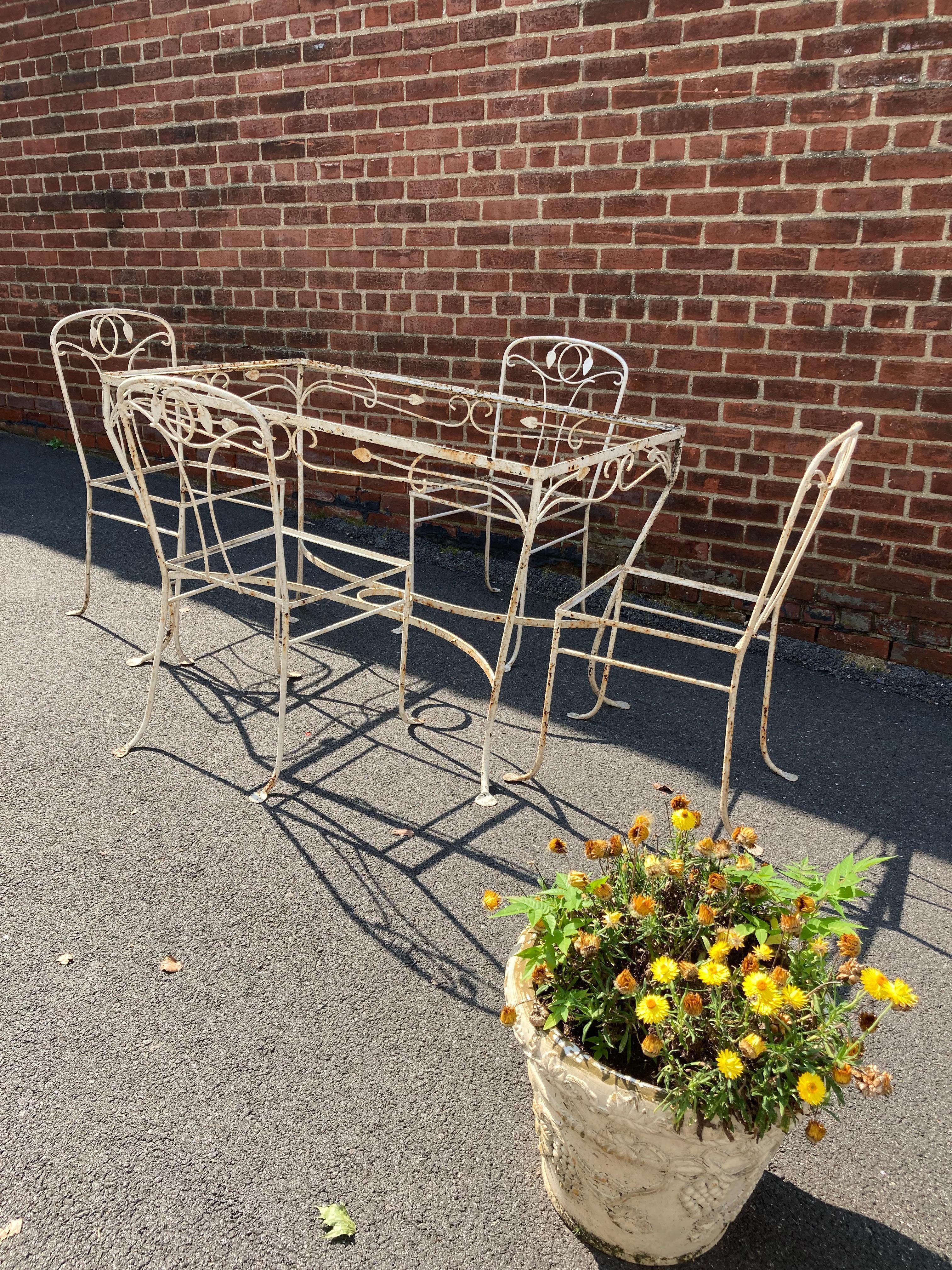 1950s Salterini wrought Iron garden set. Table and 4 chairs. Needs painting. No glass.