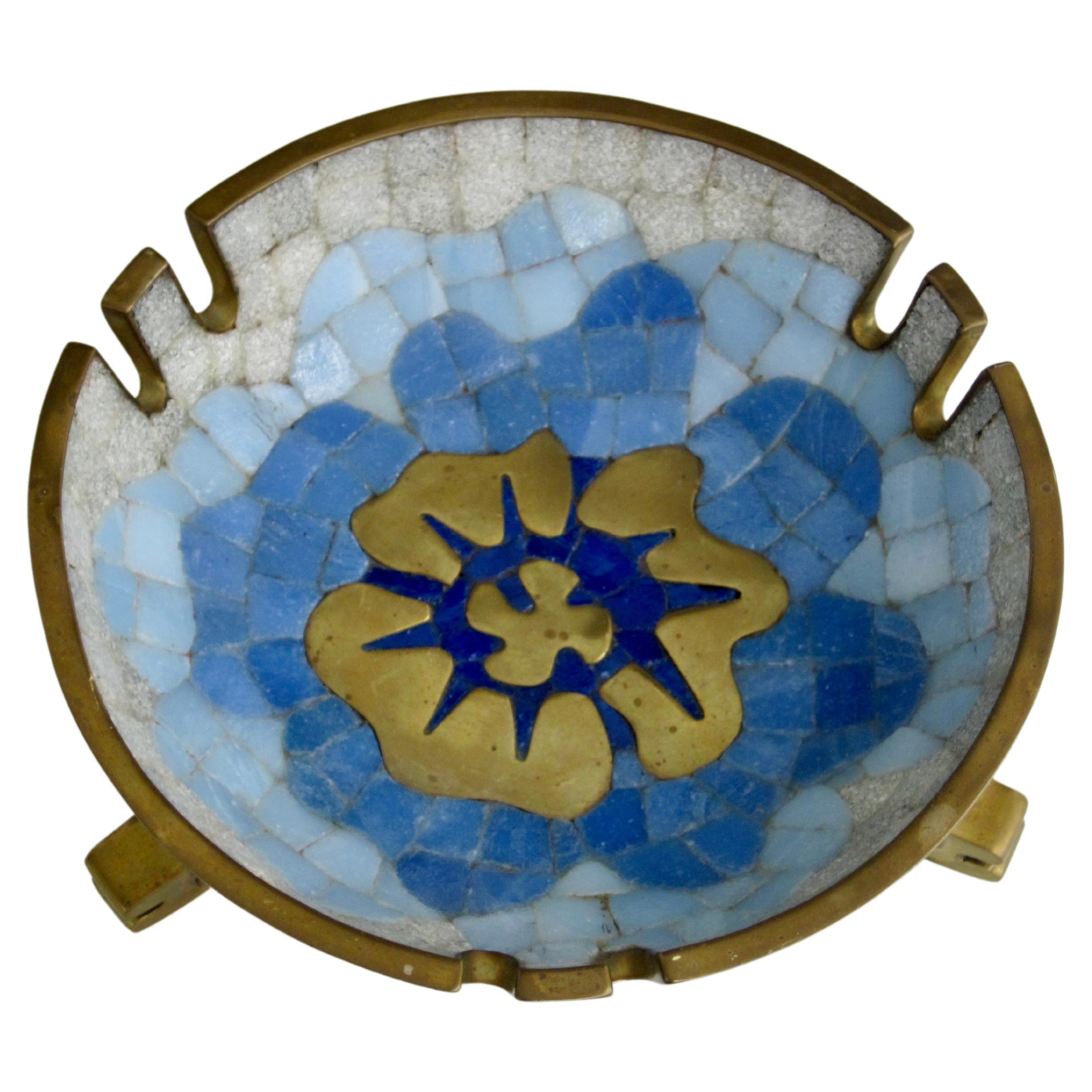 Blue and white hand cut tiles with poured brass create a flower centric look to this 1950s Salvador Teran mosaic and brass ashtray. I like the feminine feel of the soft rounded edges of the tile and poured brass and the masculine brass edging that