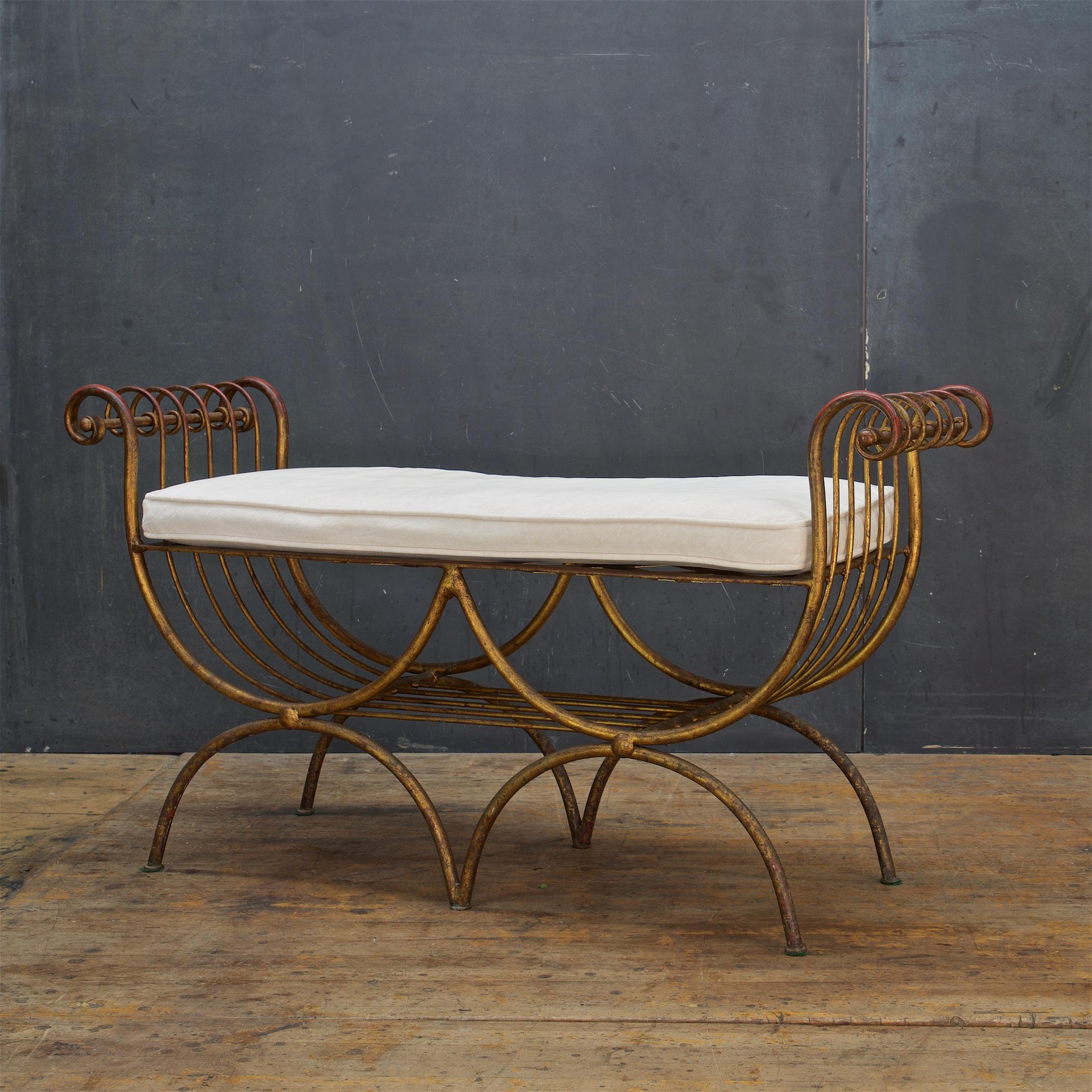 S. Salvadori 1950s Italian stool or small bench is composed of a enameled gilt metal frame with older ivory velvet cushion. Inspired by a Greek lyre harp form. Retains a metal hang tag marked, Made in Italy.

Includes soiled original upholstery, we