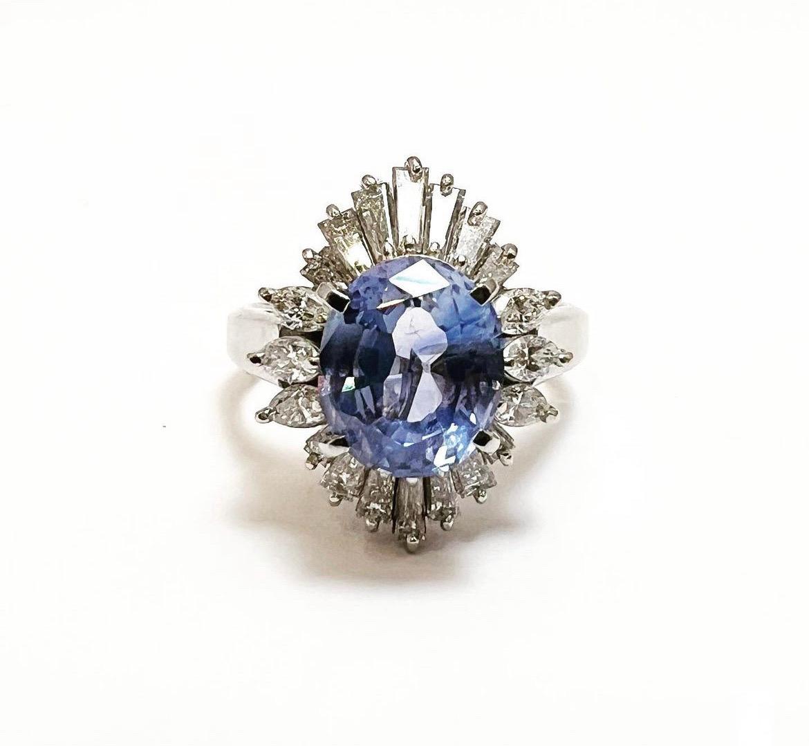 FREE SHIPPING AND RESIZING.
RETURNS ACCEPTED (3 days).

Amazing 1950s ,oval sapphire and diamonds halo platinum cluster engagement ring.
A classically designed platinum ring an oval blue sapphire surrounded by trapezoid and marquis diamonds. 
Metal: