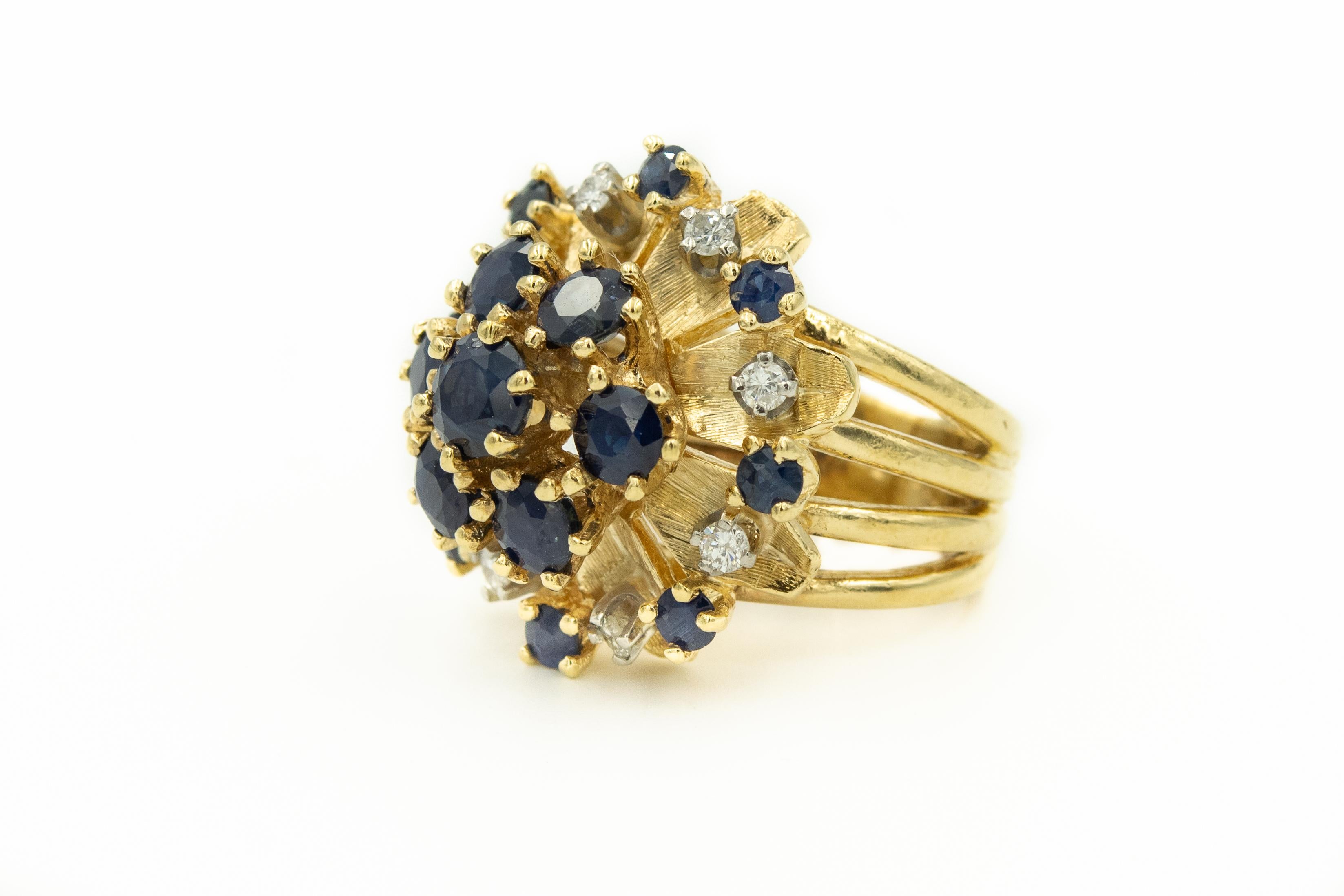 Mid 20th Century faceted sapphire and diamond flower dome cluster ring featuring a center section with larger sapphires surround by an outer area of leaves accented with smaller sapphires and diamonds.  

US size 4.5.

Marked 14k with and SA (on top