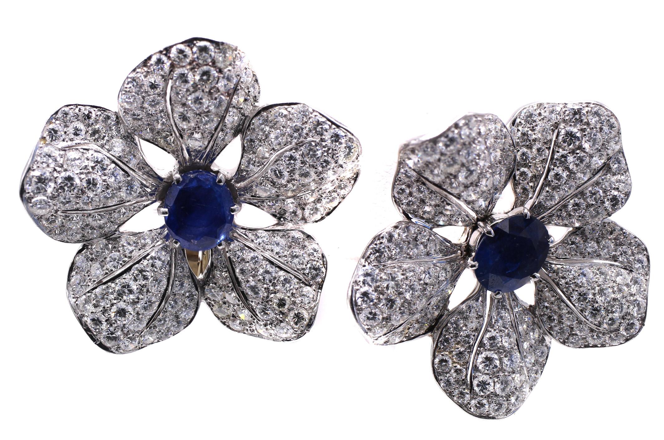 Beautifully designed and masterfully handcrafted in platinum, these 1950s ear clips make a statement on the ear. 5 realistically fashioned flower petals are set with 125 bright white and sparkly round brilliant cut diamonds on each earring, with an
