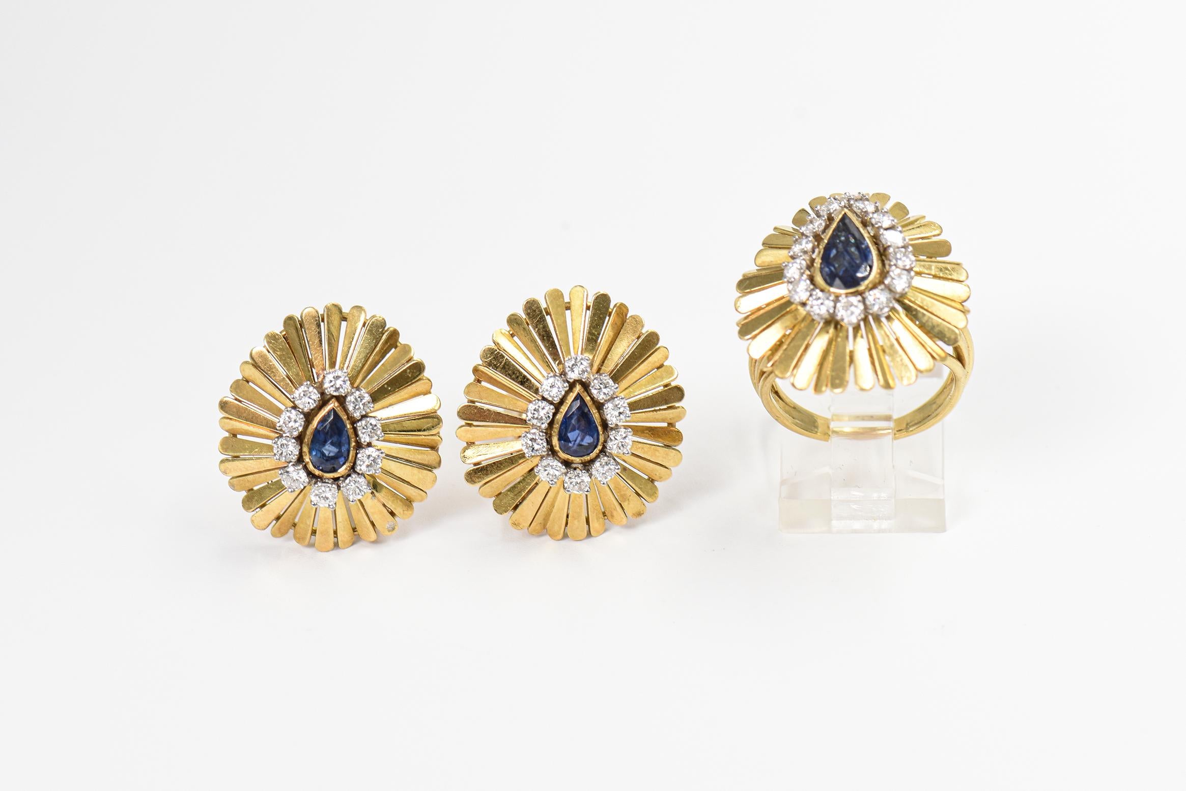 Striking three dimensional 14k yellow gold cocktail ring and clip on earrings featuring a pear shaped sapphire centrally set in a prong set diamond frame.  The outer frame consists of a teardrop ruffled elongated petals that flow up and down.  The