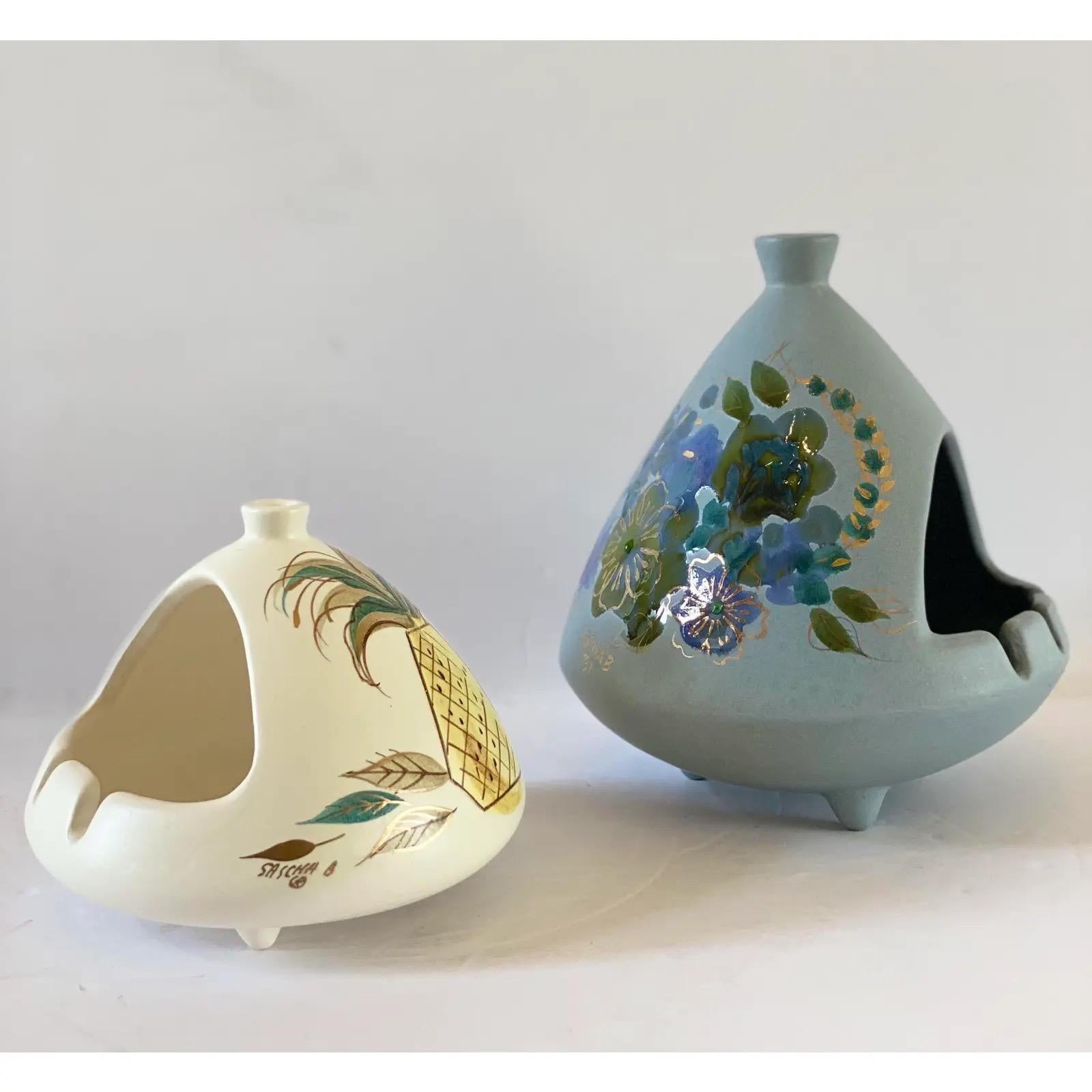 We are very pleased to offer a hand-painted, chic set of two chimney ashtrays by iconic mid-century designer Sascha Brastoff, circa the 1950s. Both pieces are signed. In excellent vintage condition. Please see all attached pictures.
Small ashtray: