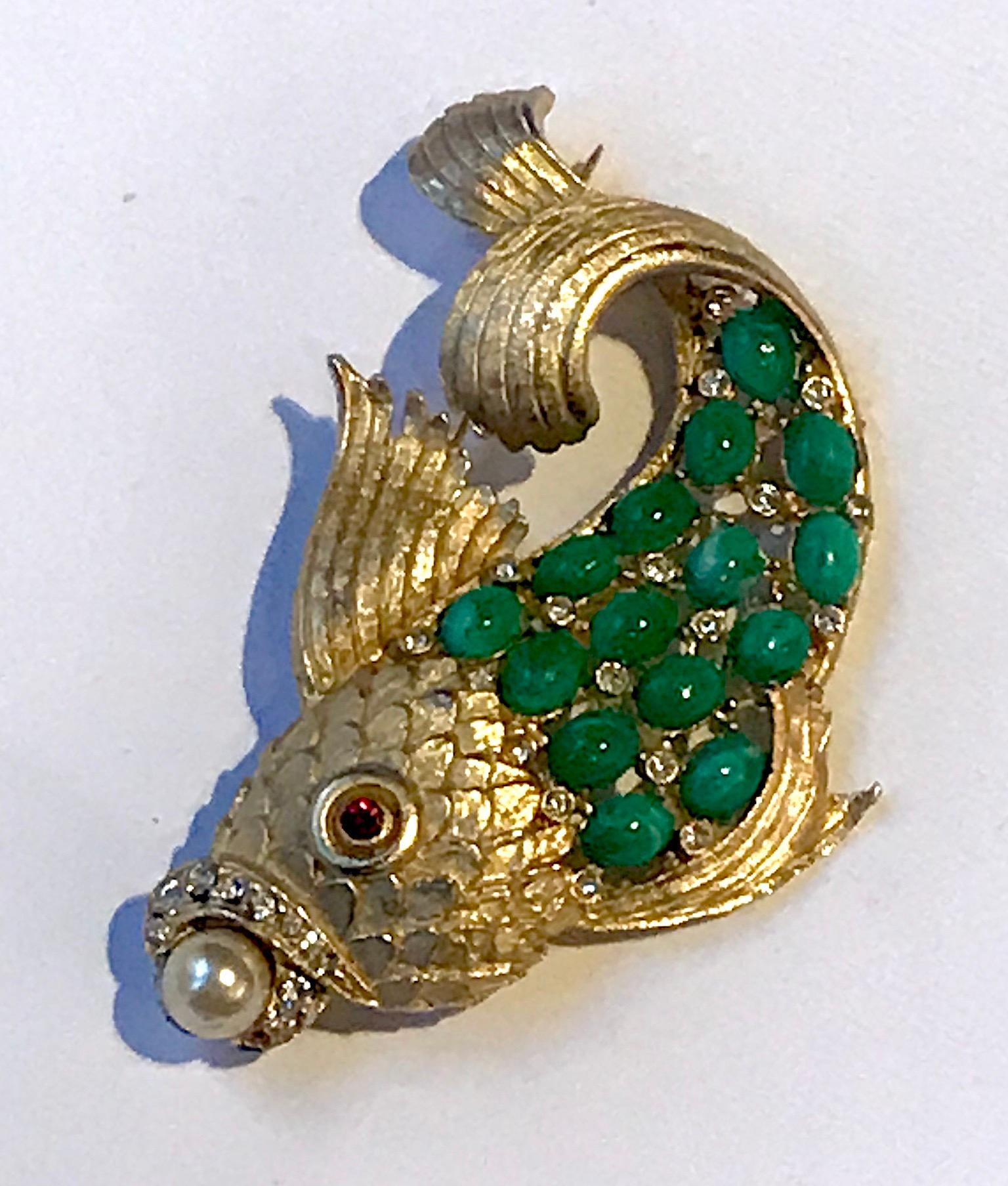A very nicely executed fish brooch from the 1950s. The body of the fish is well cast with detail in the scales and fins. There is a lovely sweeping motion in the curl of the tail and then end of the fins. The body of the fish is set with 4.5 x 6.5