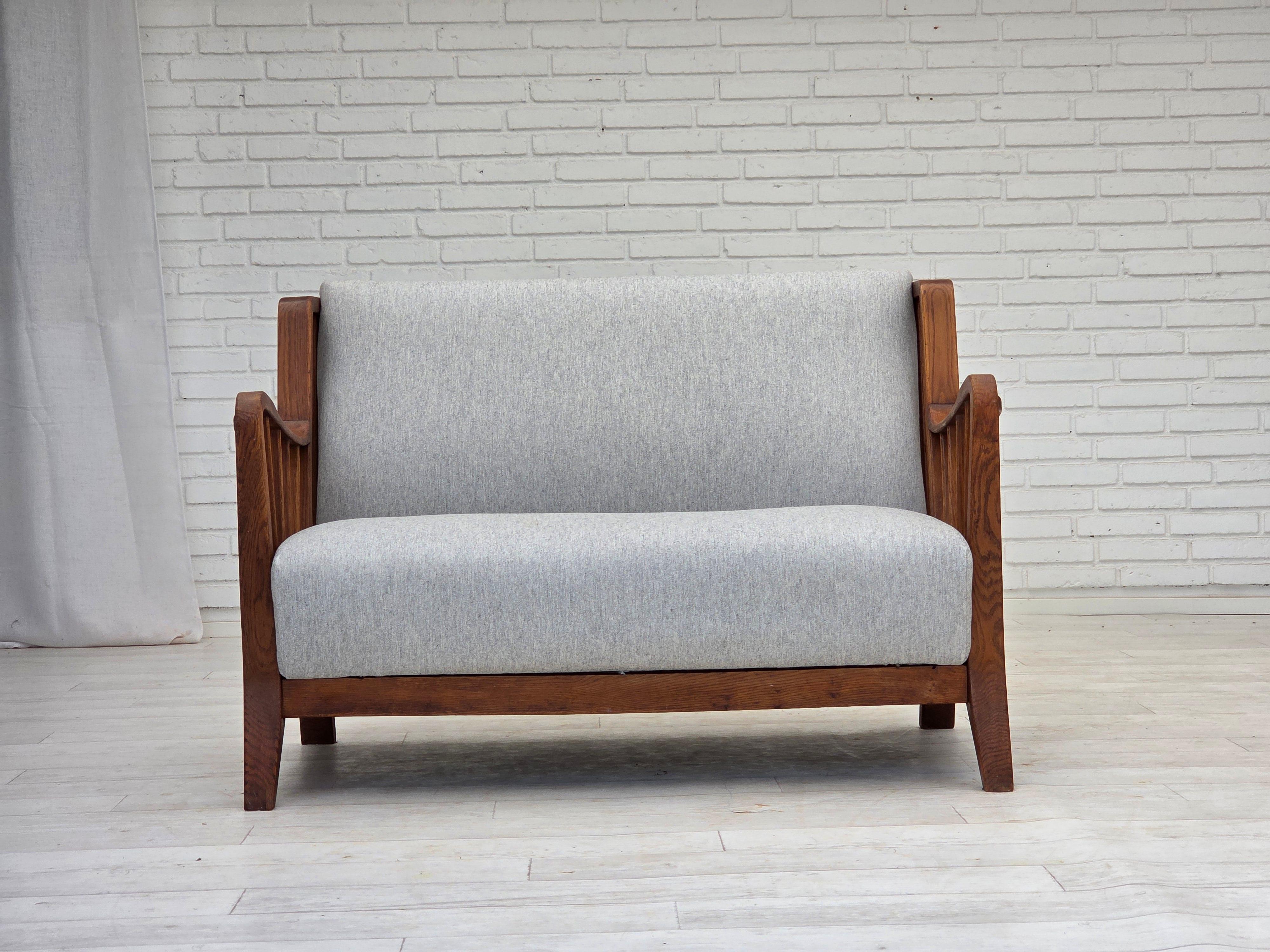 1950s, Scandinavian 2-seater sofa. Reupholstered in quality furniture wool. Renewed oak, brass springs in the seat and back. Made by Swedish furniture manufacturer in about 1950-55. Reupholstered by professional upholsterer, craftsman. Orginal