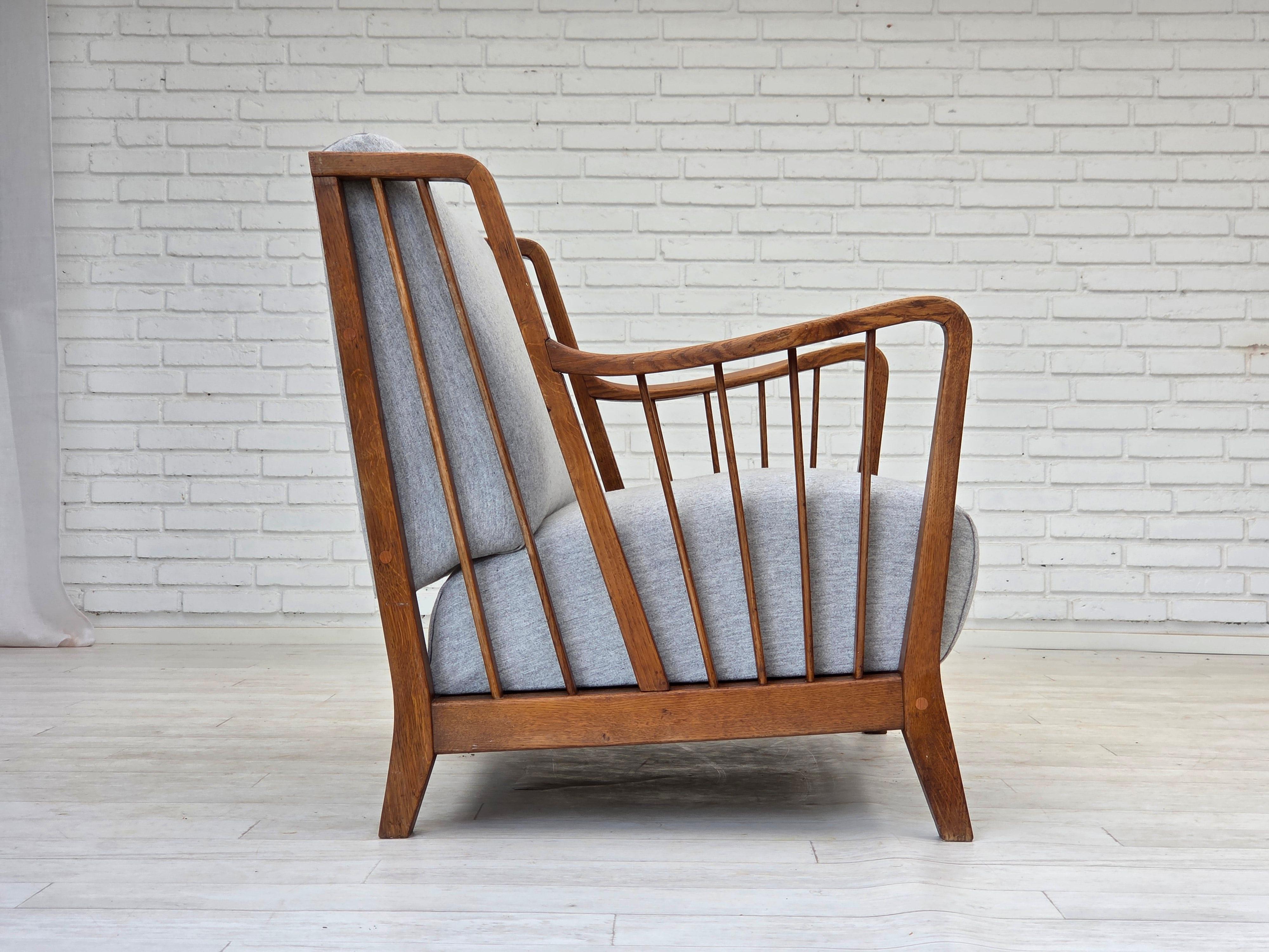 Swedish 1950s, Scandinavian 2-seater sofa, reupholstered, furniture wool, oak. For Sale