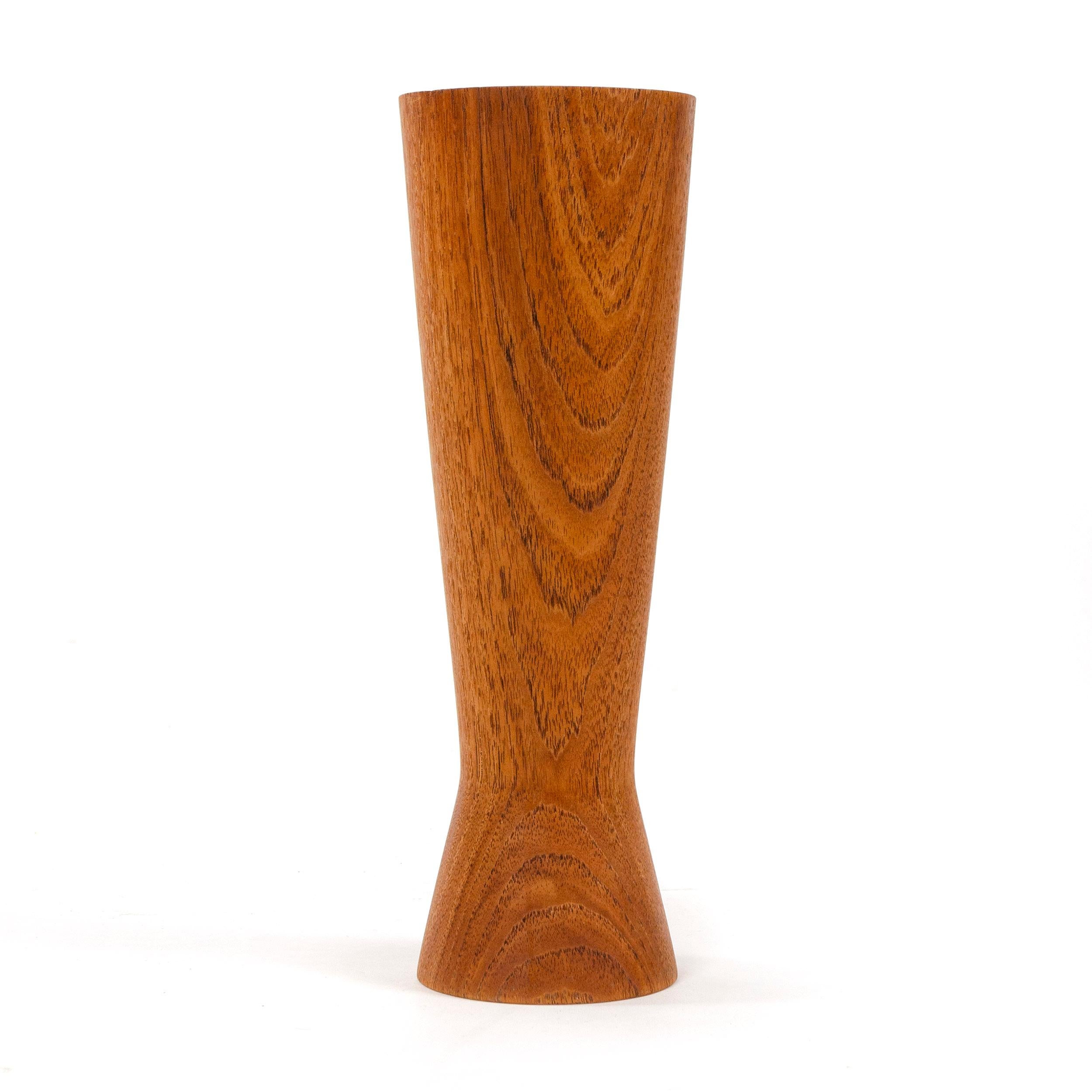 A turned teak vase with a cinched waist.