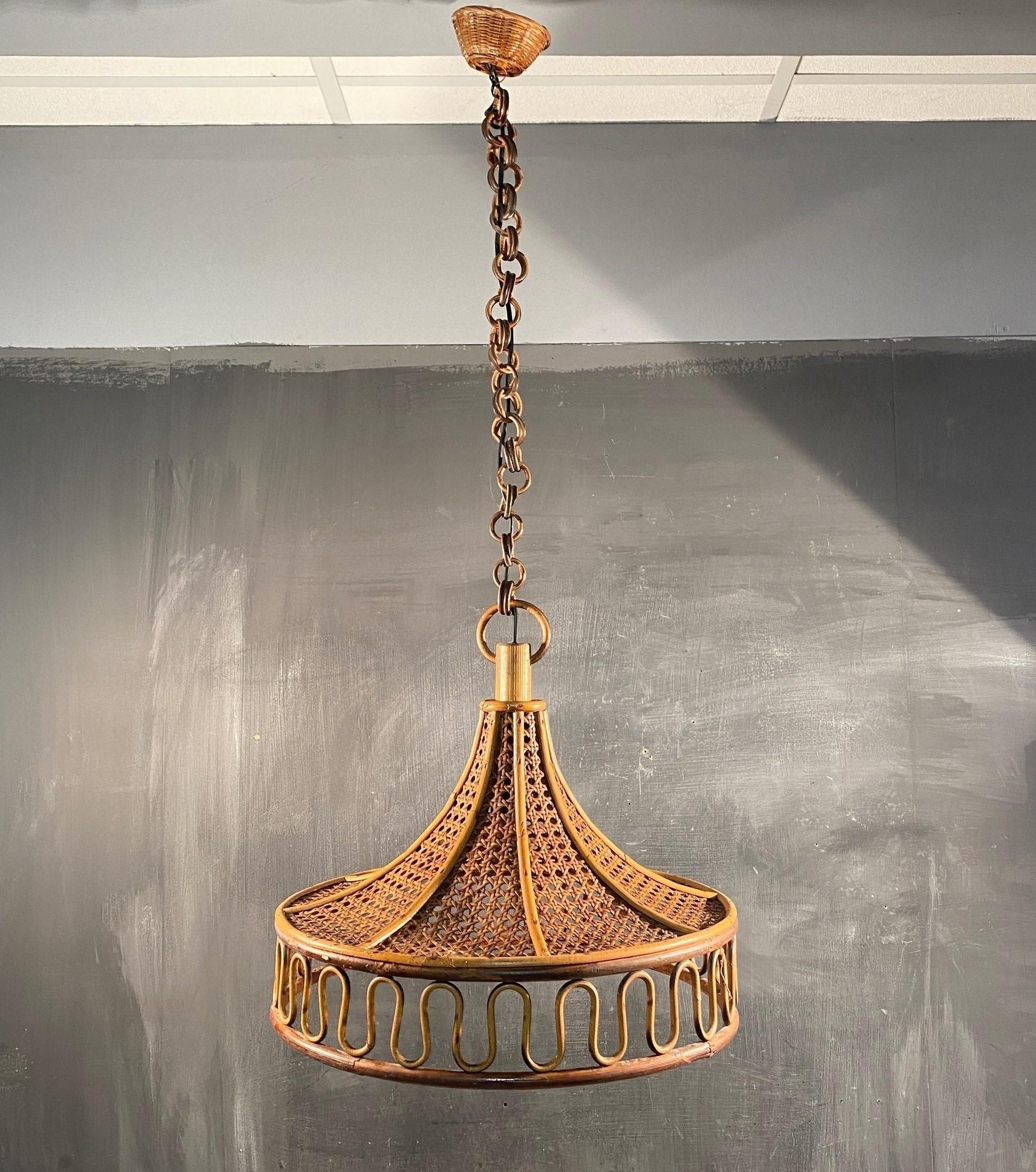 Mid-century bamboo and wicker pendant, Denmark, 1950s. This beautiful suspension lamp is entirely handcrafted in bamboo and woven wicker provinding a warm and pleasant light. The chain is composed of bamboo round links topped by a wicker canopy. The