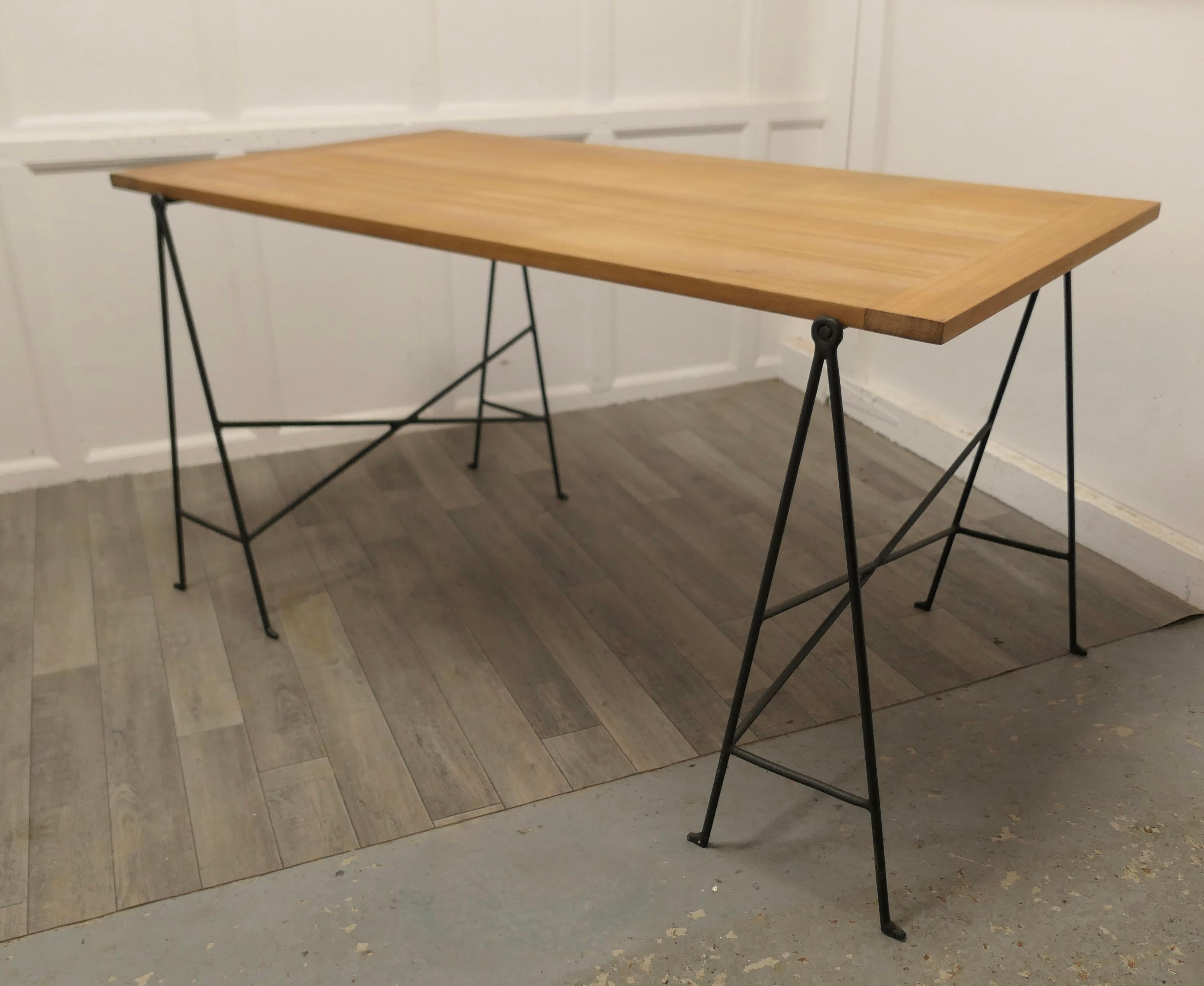 1950s Scandinavian sawhorse minimalist desk or table.

A very popular classic design from the 1950s, the solid teak top with cleated ends is supported on a pair of very stylish metal sawhorse legs
The table will seat 6 comfortably or it makes a