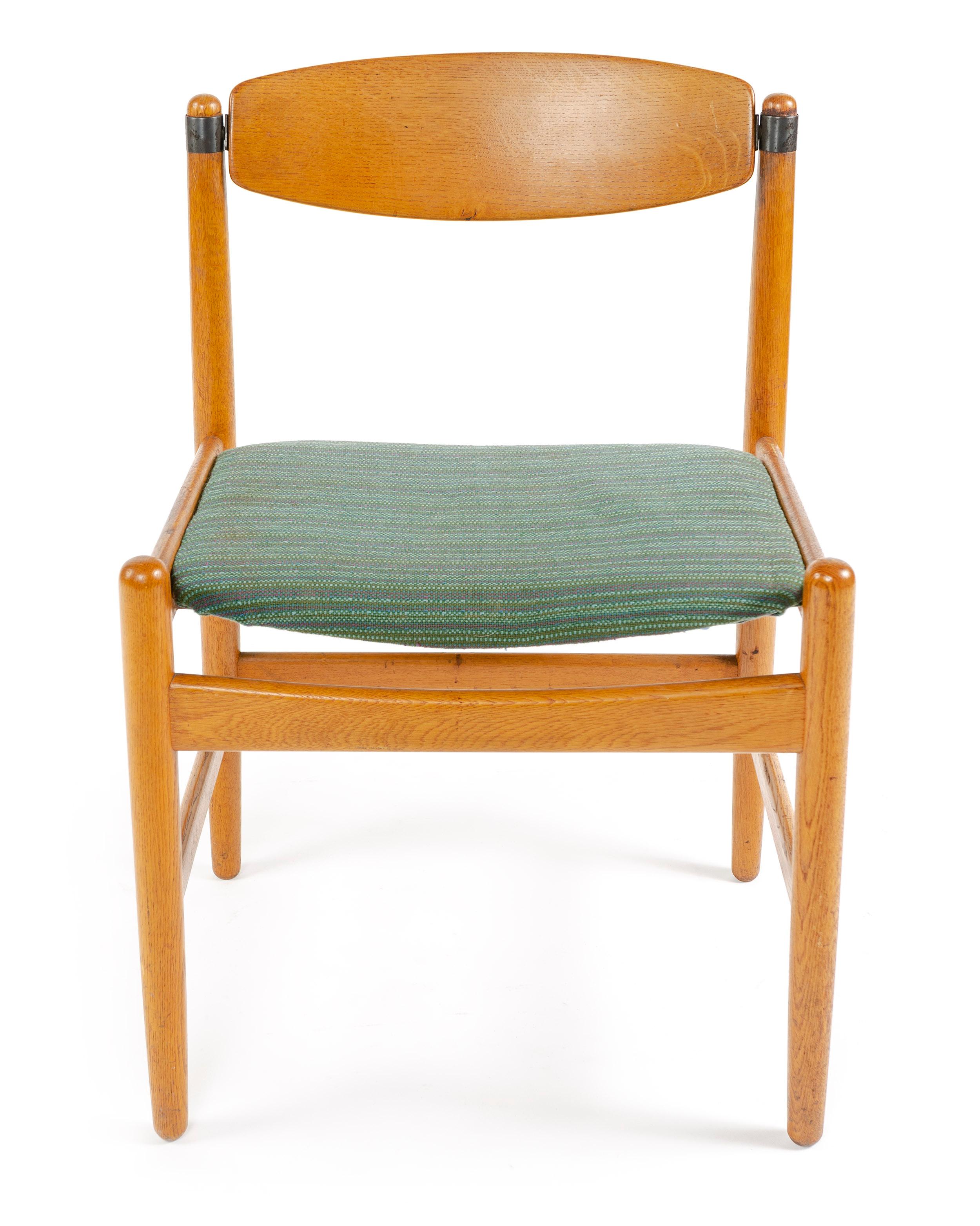 An oak dining chair with a pivoting backrest and upholstered seat. Two chairs available with arms (24