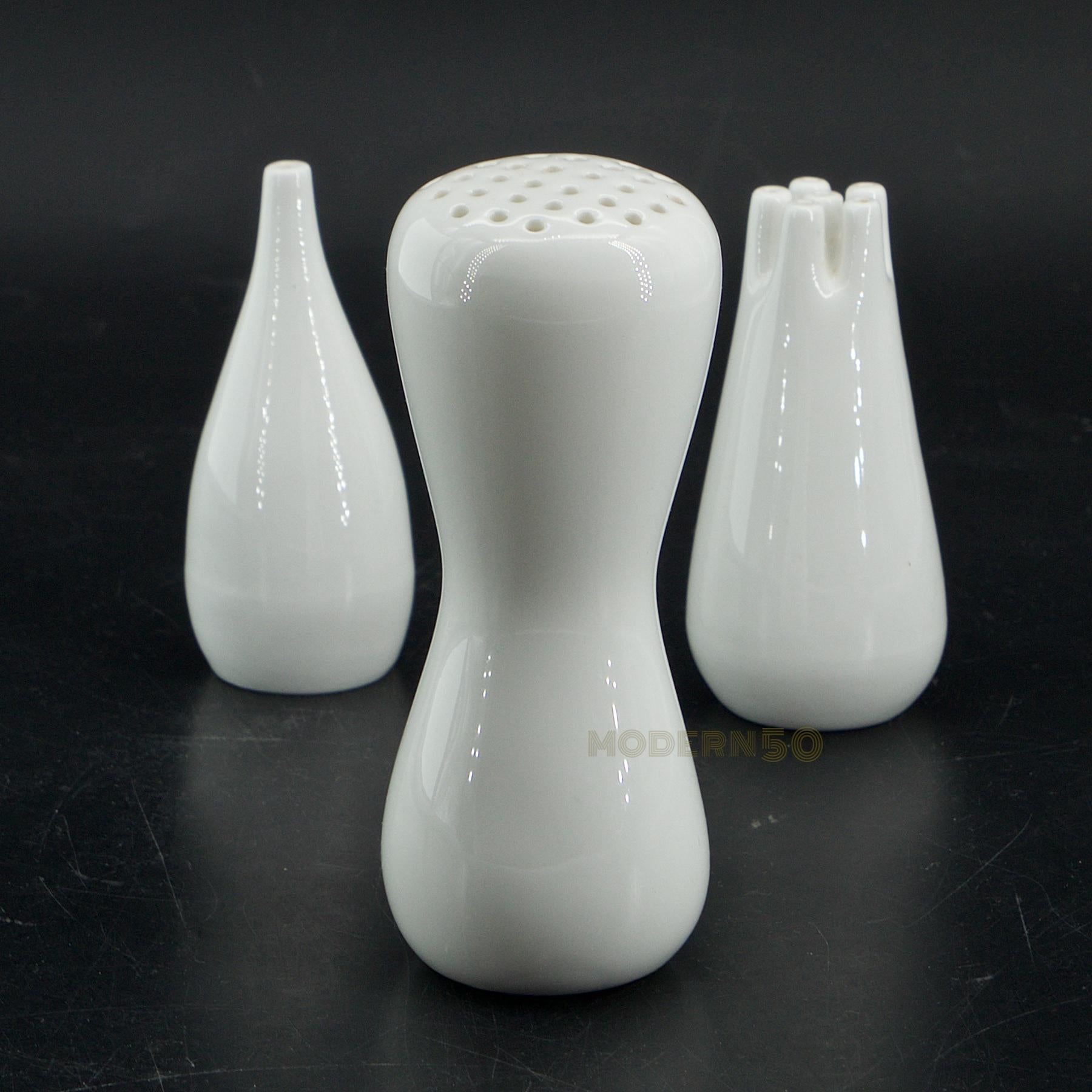 Rare museum worthy biomorphic pure white 'bone china' salt, pepper, and sugar/cinnamon shakers. 

Measures: Salt and pepper diameter 1.25 x height: 3 in.
Sugar shaker diameter 1.75 x height 4.25 in.
 