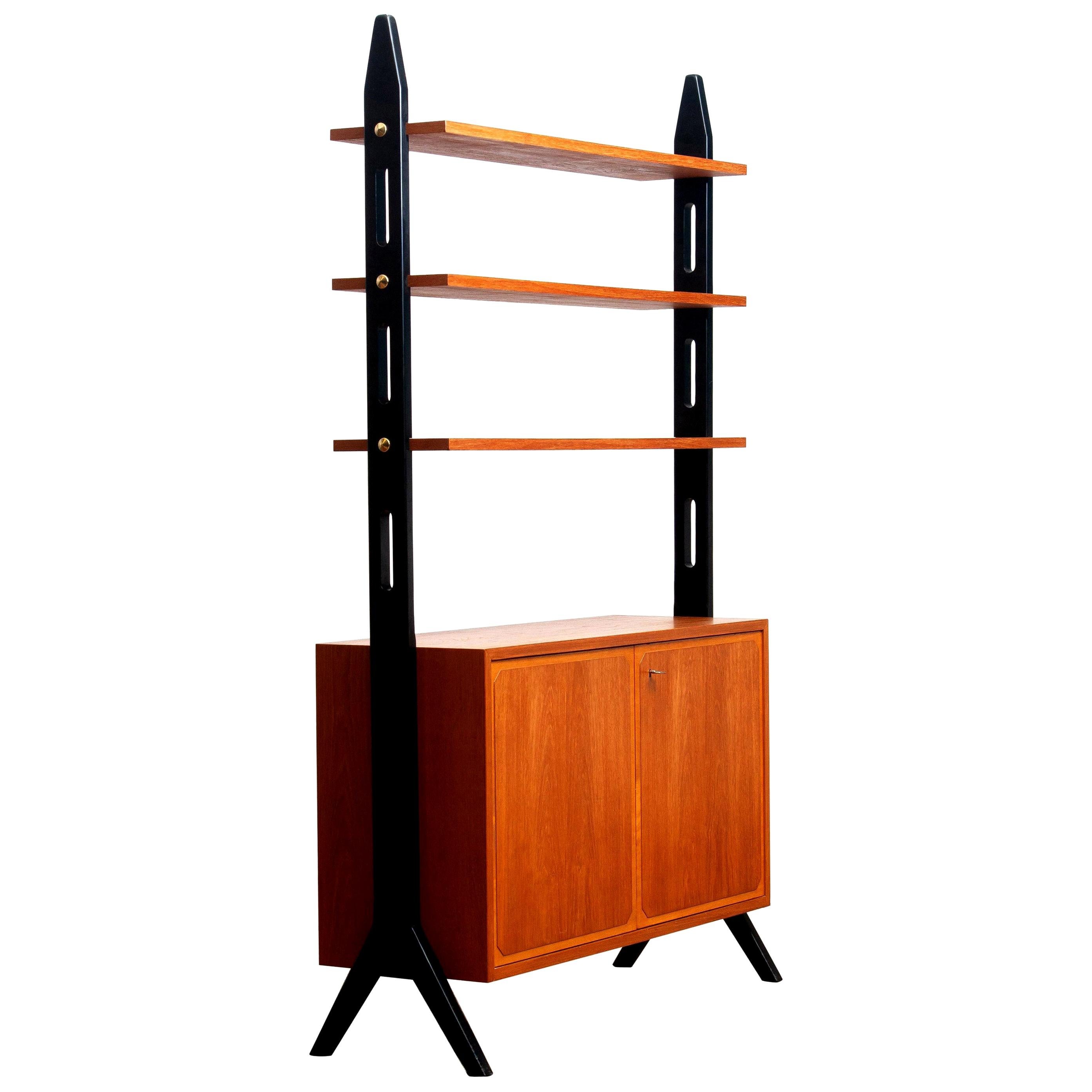 Beautiful Swedish bookcase or room divider or shelf’s made in teak from the 1950s.
Two folding doors, with a lock, inside the cabinet is a shelf that can be adjusted in two positions.
The three top shelf’s are placed in a fixed position.
Overall