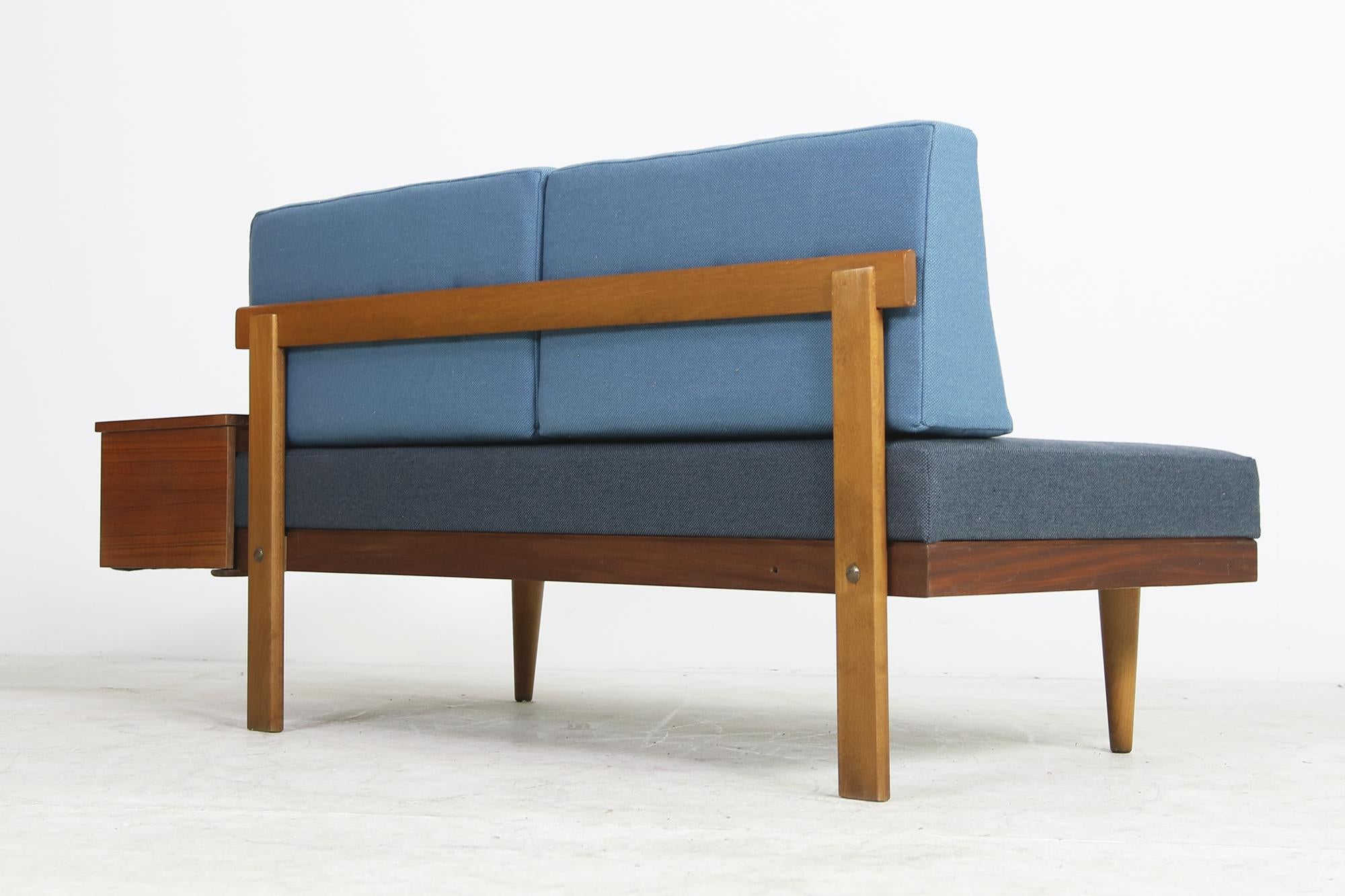 Beautiful Norwegian Mid-Century Modern daybed from the 1950s in fantastic condition. Teak and beech base in great condition, also possible using it as a daybed, the side table can be extended, newly covered in beautiful blue tones.

Sofa