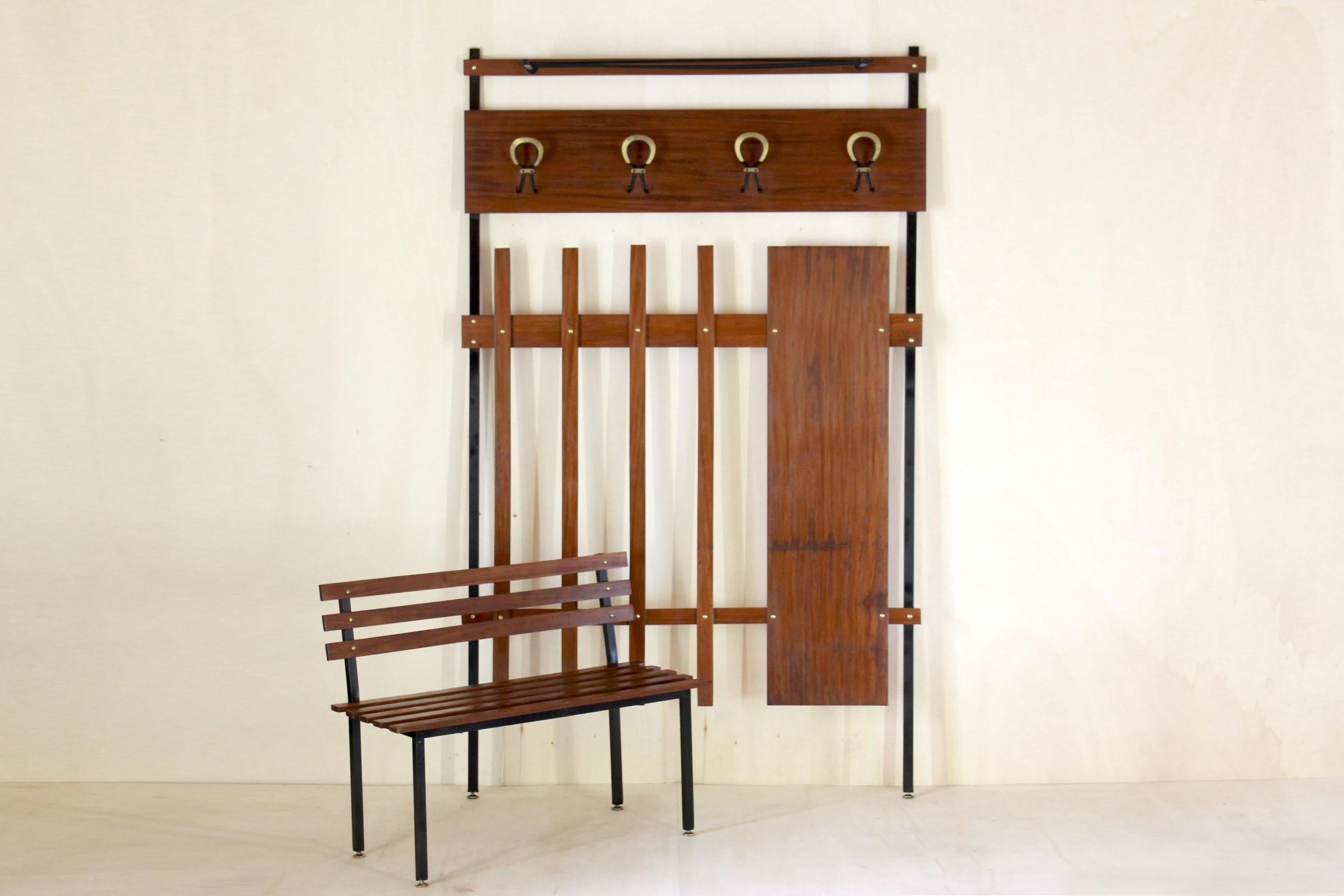 A beautiful home entrance set form the 1950s in pure Scandinavian style. The set is made by a coat rack in iron and teak with small brass feet, a teak wood consolle and a small wood bench and brass feet. In excellent conditions with only few signs