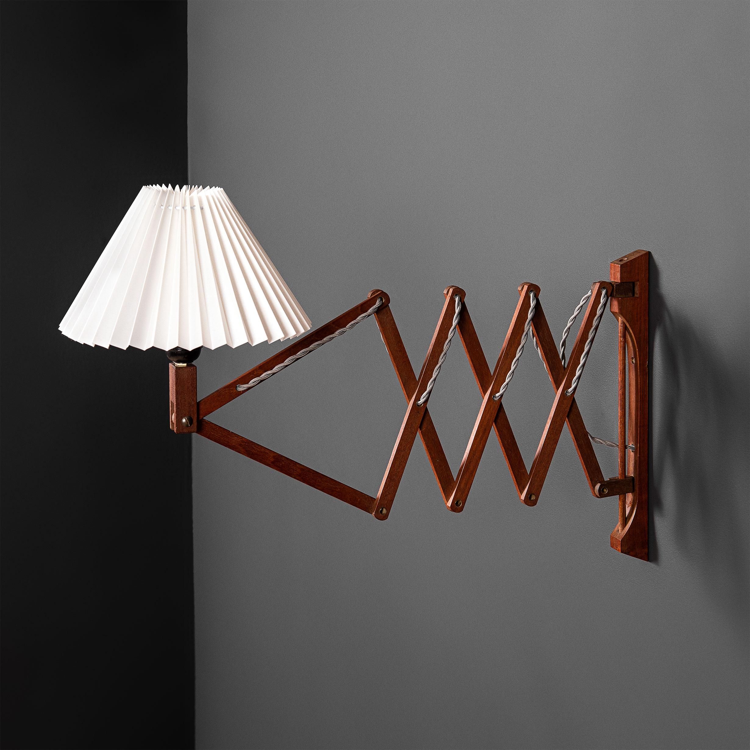 An early Scandinavian scissor extending wall lamp. Produced circa 1950. Smooth movement. Currently wired with a cable to wall circuit installation. U.S overseas and cable to plug-in wiring is available on request. 
 