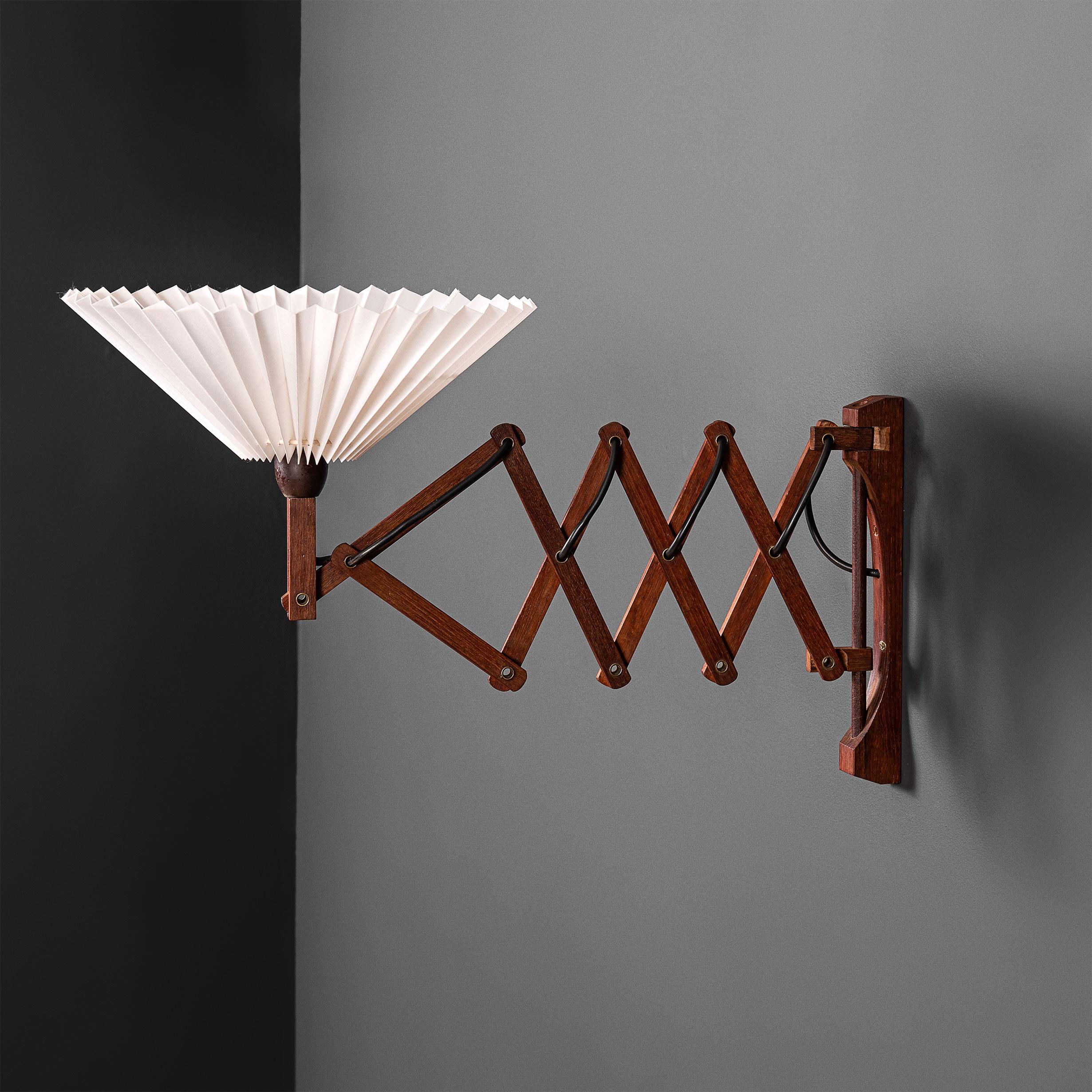 An 1950's Scandinavian scissor extending wall lamp. Produced in Denmark circa 1950. Smooth movement. This lamp can be fitted upwards or downwards. Currently wired with a cable to wall circuit installation. U.S overseas and cable to plug-in wiring is