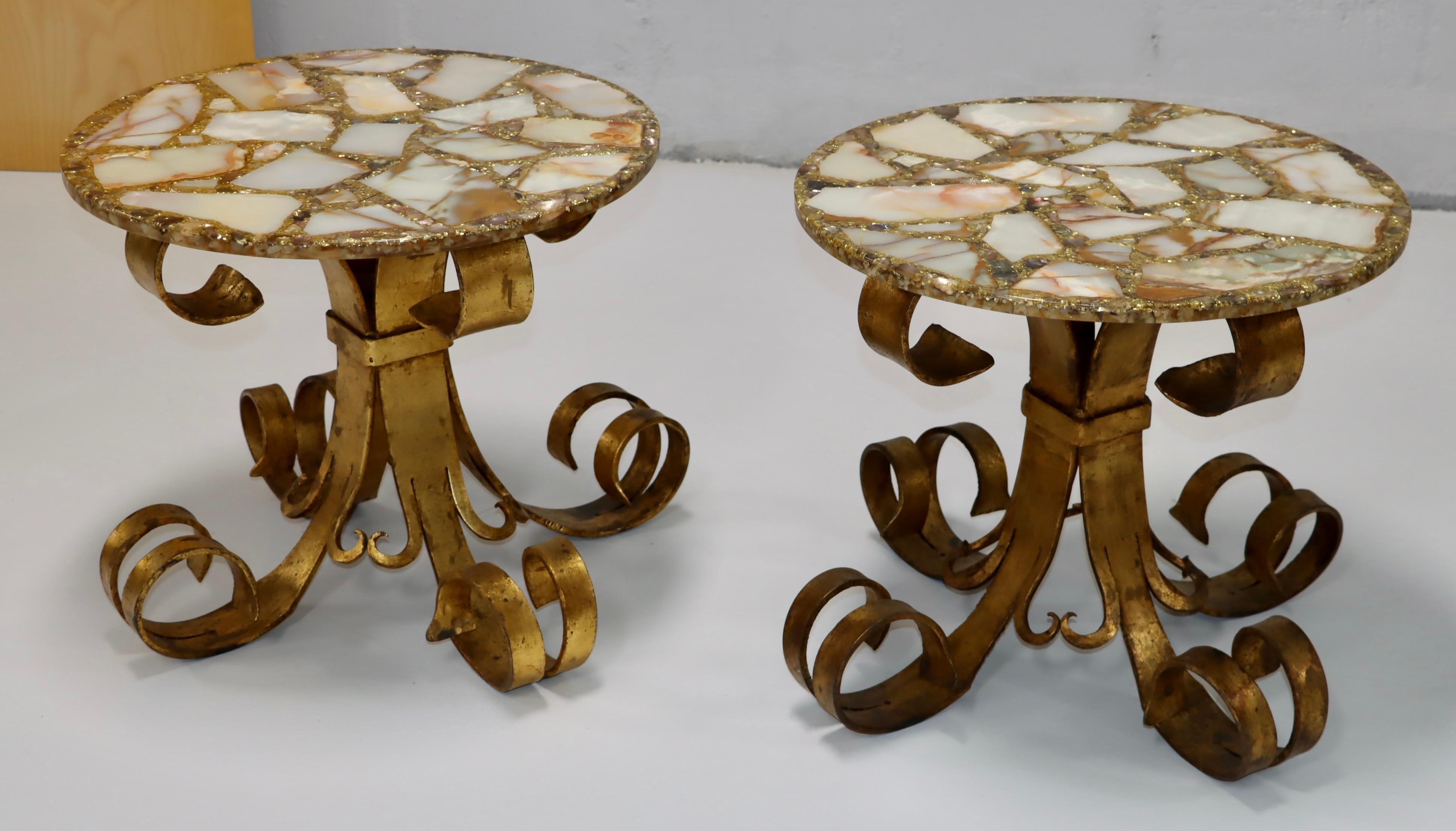 1950s solid iron torch cut brutalist style scrolled side tables with gilt finish and onyx and resin tops, in vintage original condition with some wear and patina to the gilt finish due to age and use.
