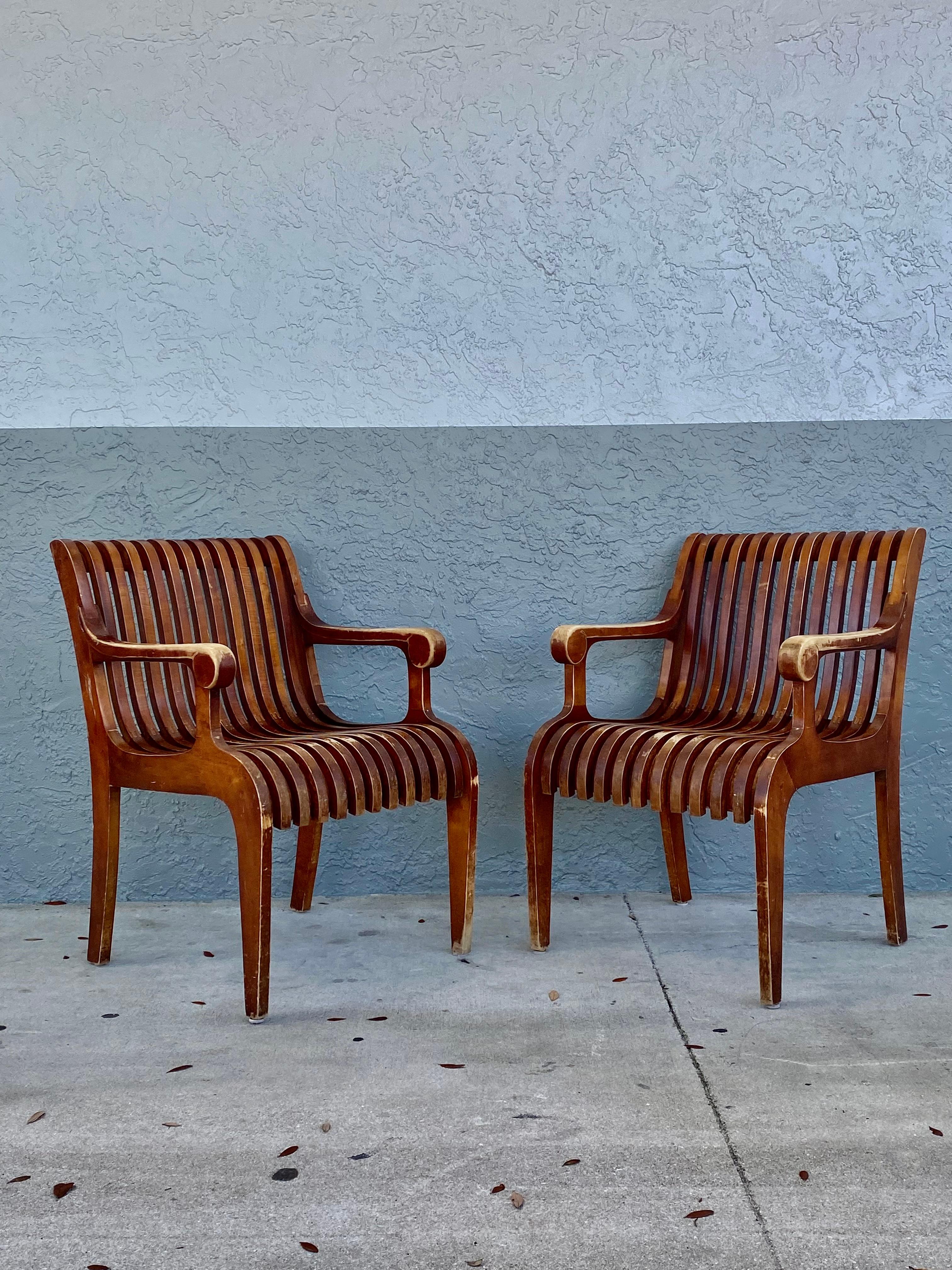 These extremely rare and stylish original bentwood chairs are packed with personality! Outstanding design is exhibited throughout. Just look at the curves and details on this beauty! Sculptural slatted bentwood slats are molded to follow the curves