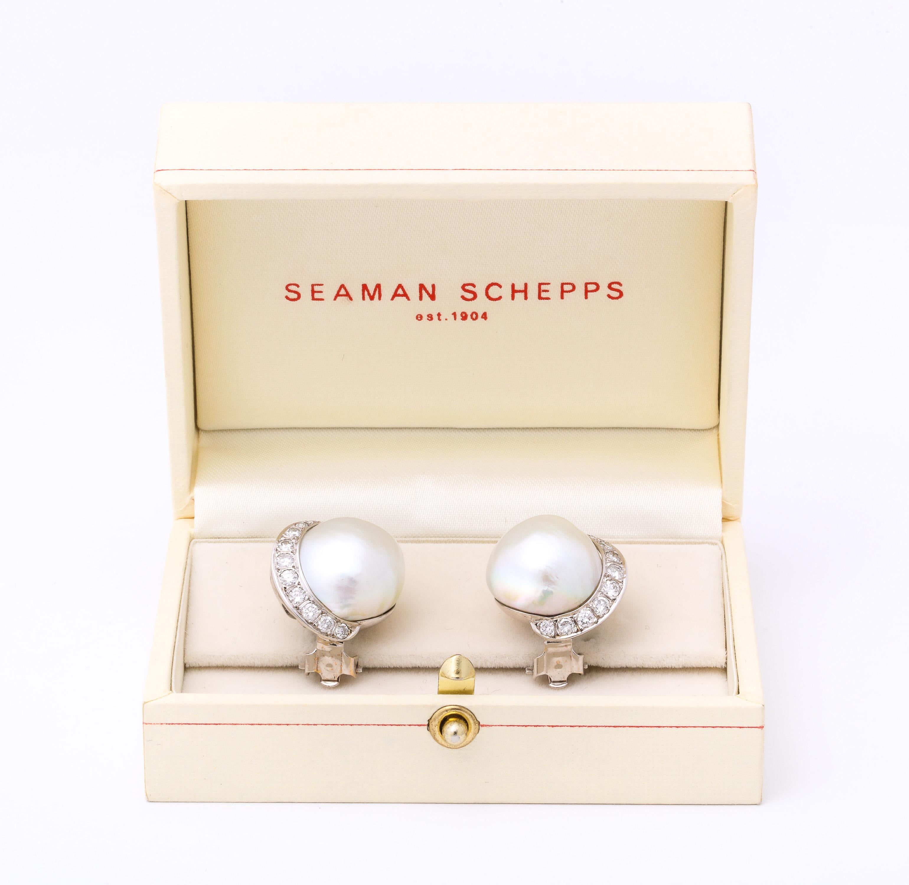 One Pair Of 14kt White Gold Earclips Composed Of A 20 Mm Mabe Pearl And Flanked By Numerous Full Cut Diamonds Weighing Approximately 1 .50 Carat Total Weight.Signed Seaman Schepps Created In The 1950's In The United states Of America.