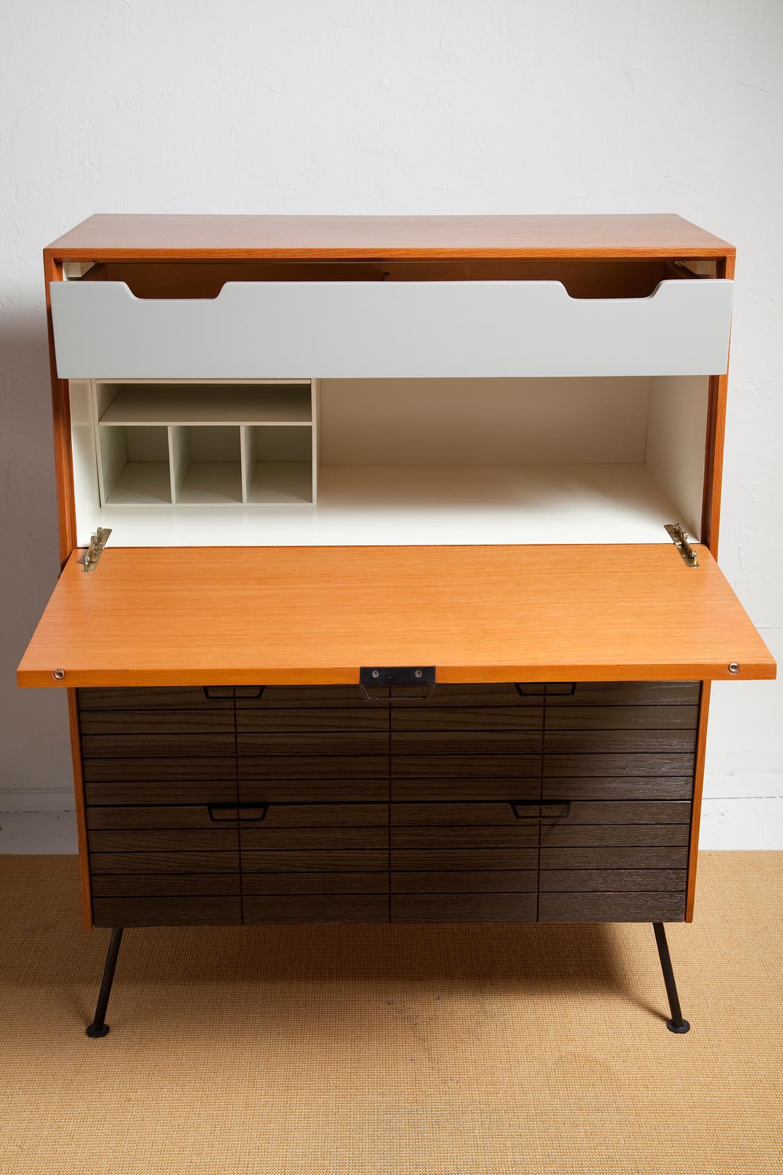 As handsome as it is practical, we've freshened this 1950s secretary desk by Raymond Loewy for Mengel to near pristine condition. We've refinished the outer cabinet and desktop and given the interior a fresh cream color accented by a dove grey