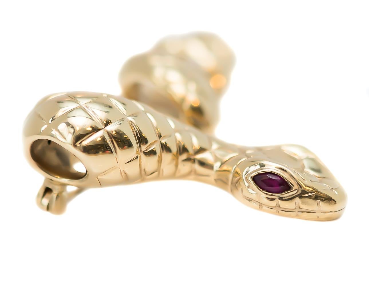 1950s Retro Serpent Brooch, Rattlesnake Pin - 14 Karat Yellow Gold, Rubies

Features:
2 Marquise cut Ruby Eyes
14 karat Yellow Gold Body
Diamond Textured Body
Rattle Texture on End of Tail
Flat, Diamond Shaped Head
Smooth Underside 
Measures 5 x 3.5