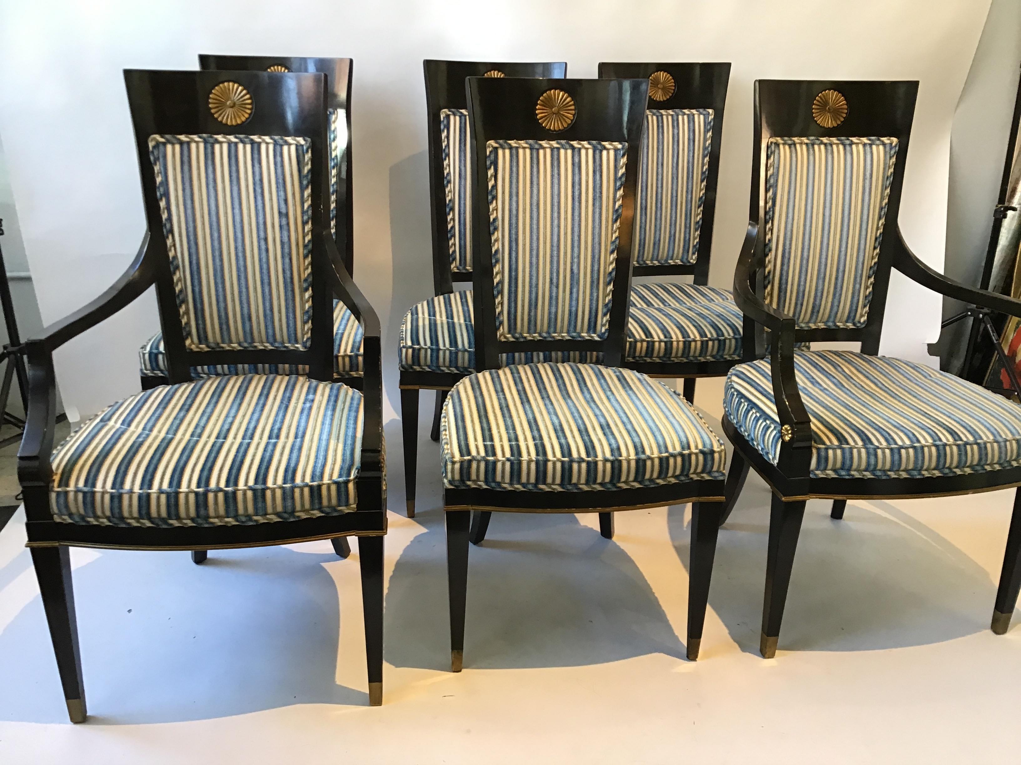 Set of 6 ebonized Regency style dining chairs from the 1950s. 2 arm and 4 sides. Sunburst backs.
