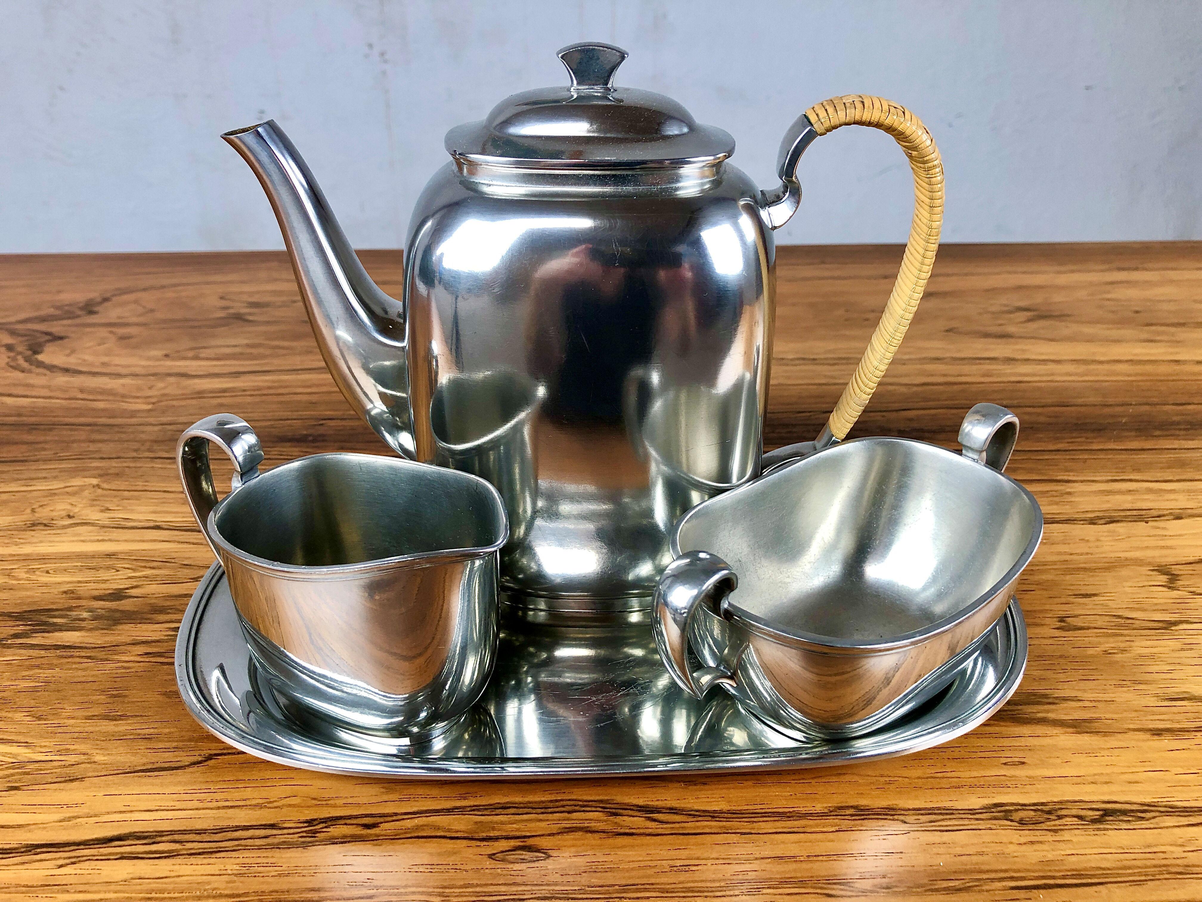 1950s Set of Danish Just Andersen Pewter coffee service 

The set consisting of a coffee pot, creamer, sugar bowl and a tray all marked with Just Andersens triangle mark is in good vintage condition.

Sizes cm/in:
Coffe pot: H: 17 / 6.69 D: 9 /