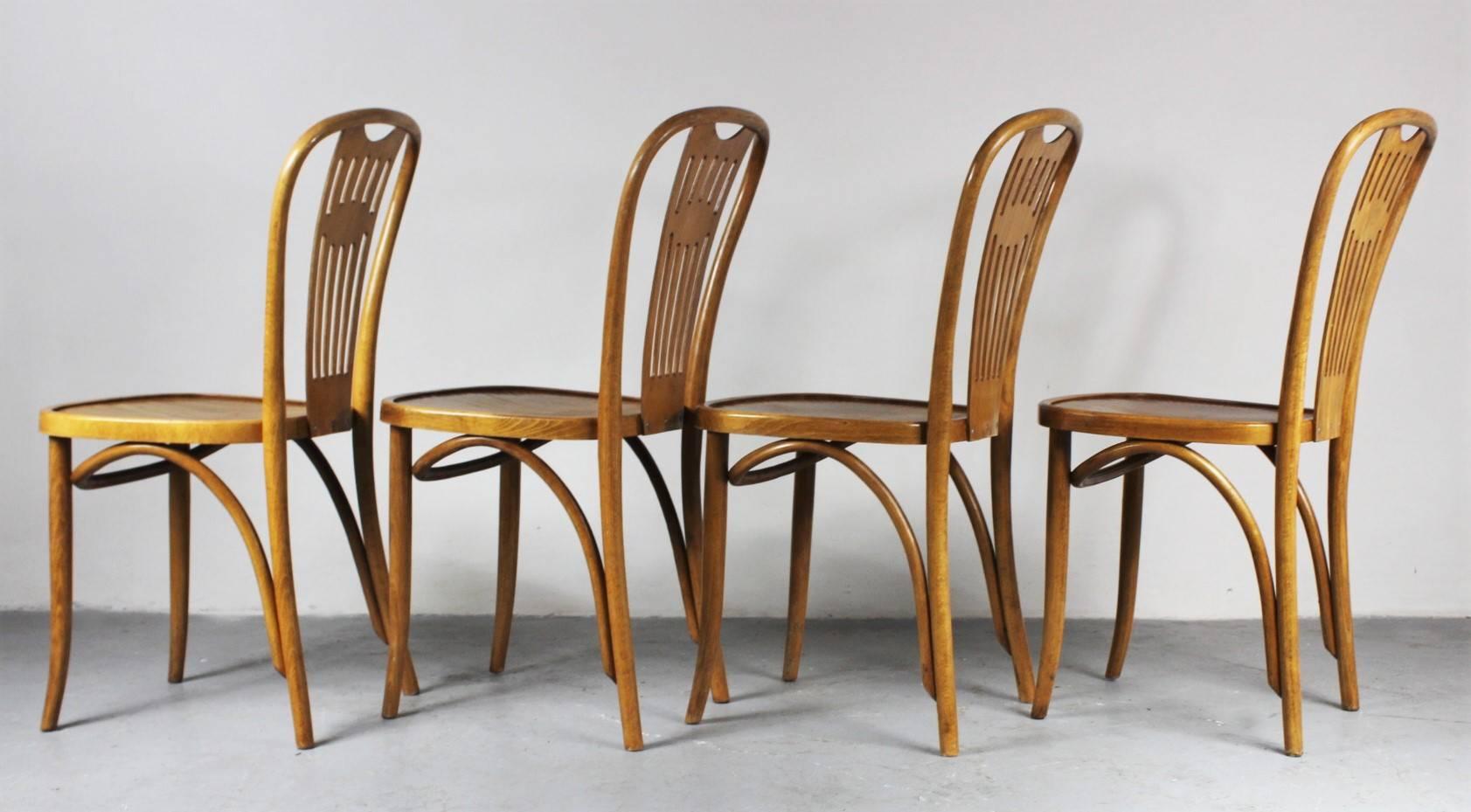 Set of four Thonet bistro chairs from the 1950s. Floral decoration on the seat. Chairs are in good original condition.
