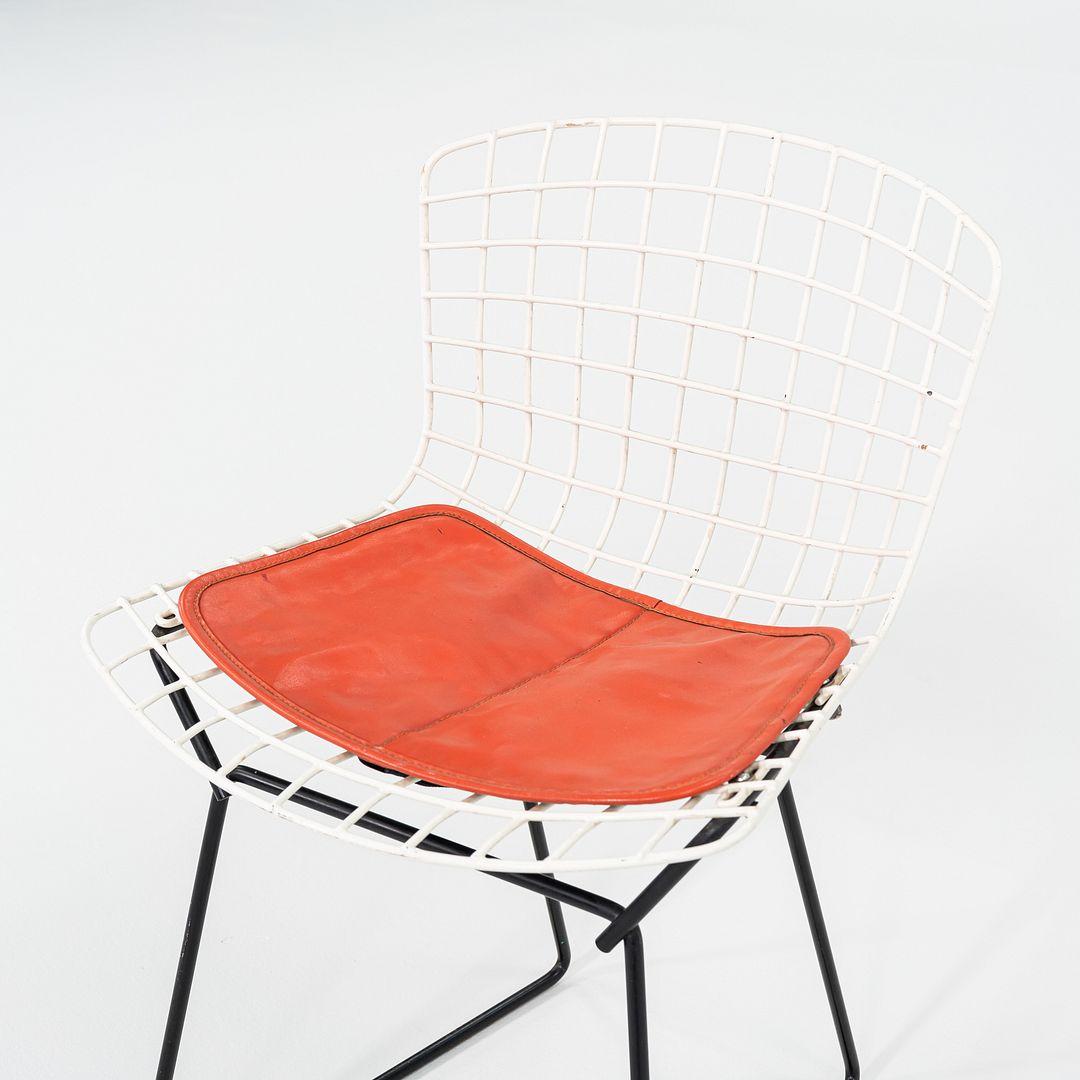 This is a set of four Child's Bertoia Side Chair with seat cushion, originally designed by Harry Bertoia in 1955. These particular examples were produced by Knoll in the USA in the 1950s. The design is comprised of welded steel rods, the seat being