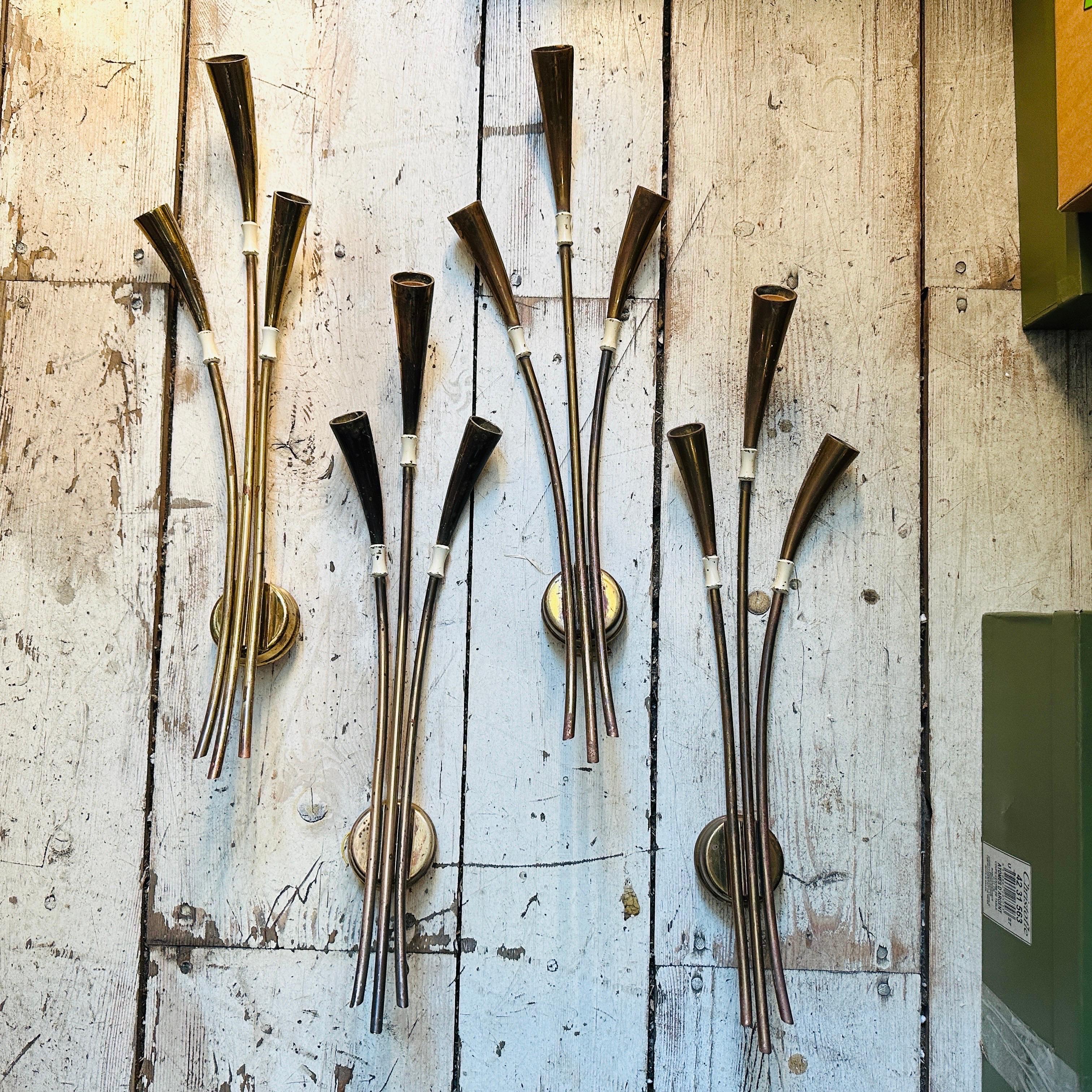 An amazing set of four sconces designed by Oscar Torlasco and produced by Lumi Milano in the Fifties. They are in working order with the original electrical system. The brass is in its original patina and can be easily cleaned; they have normal