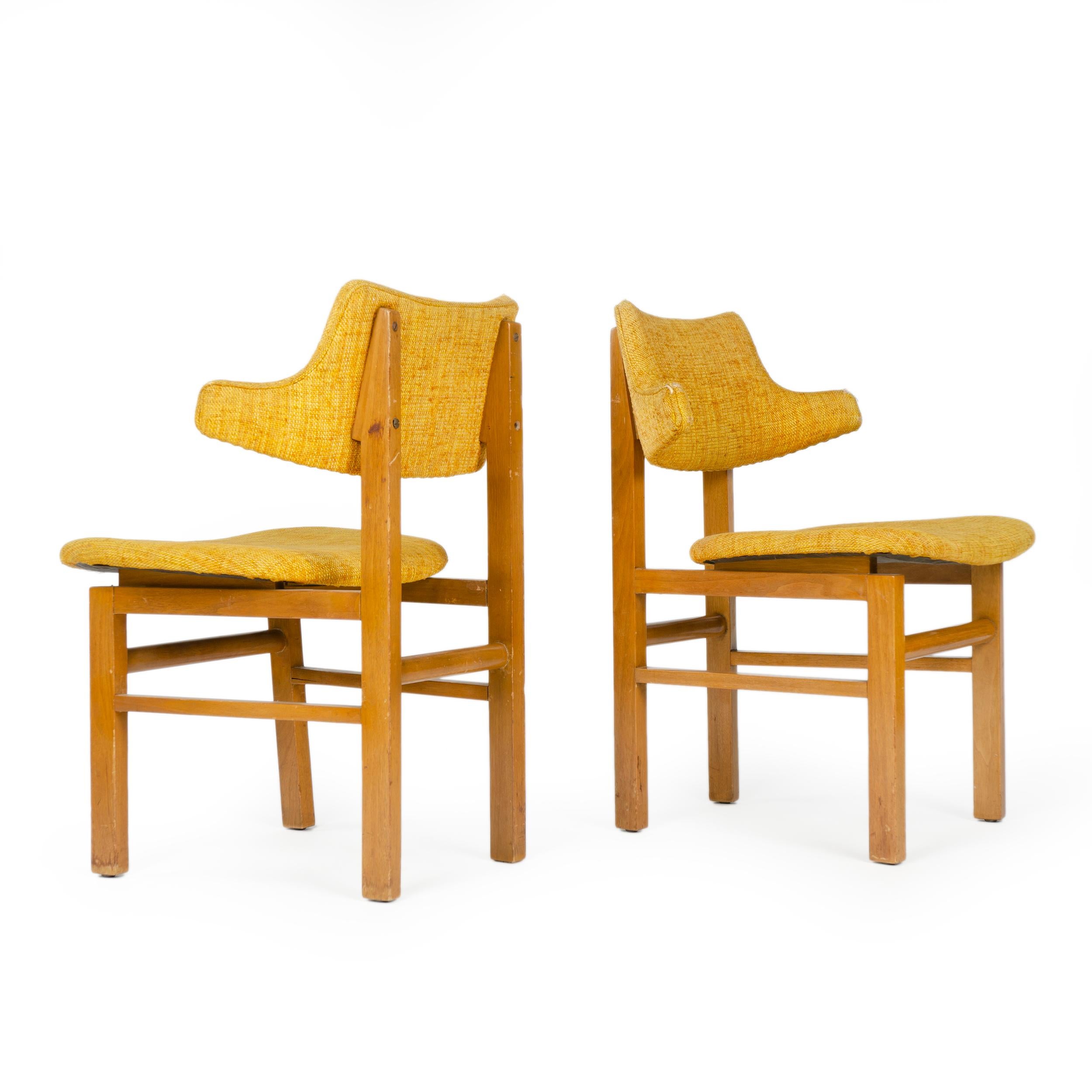 A set of dining chairs with exposed walnut frames supporting floating laminated seats and sculptural back rests, both covered in vintage upholstery. Designed in 1953 as a component of the newly introduced Career Group, produced through 1957. Listing