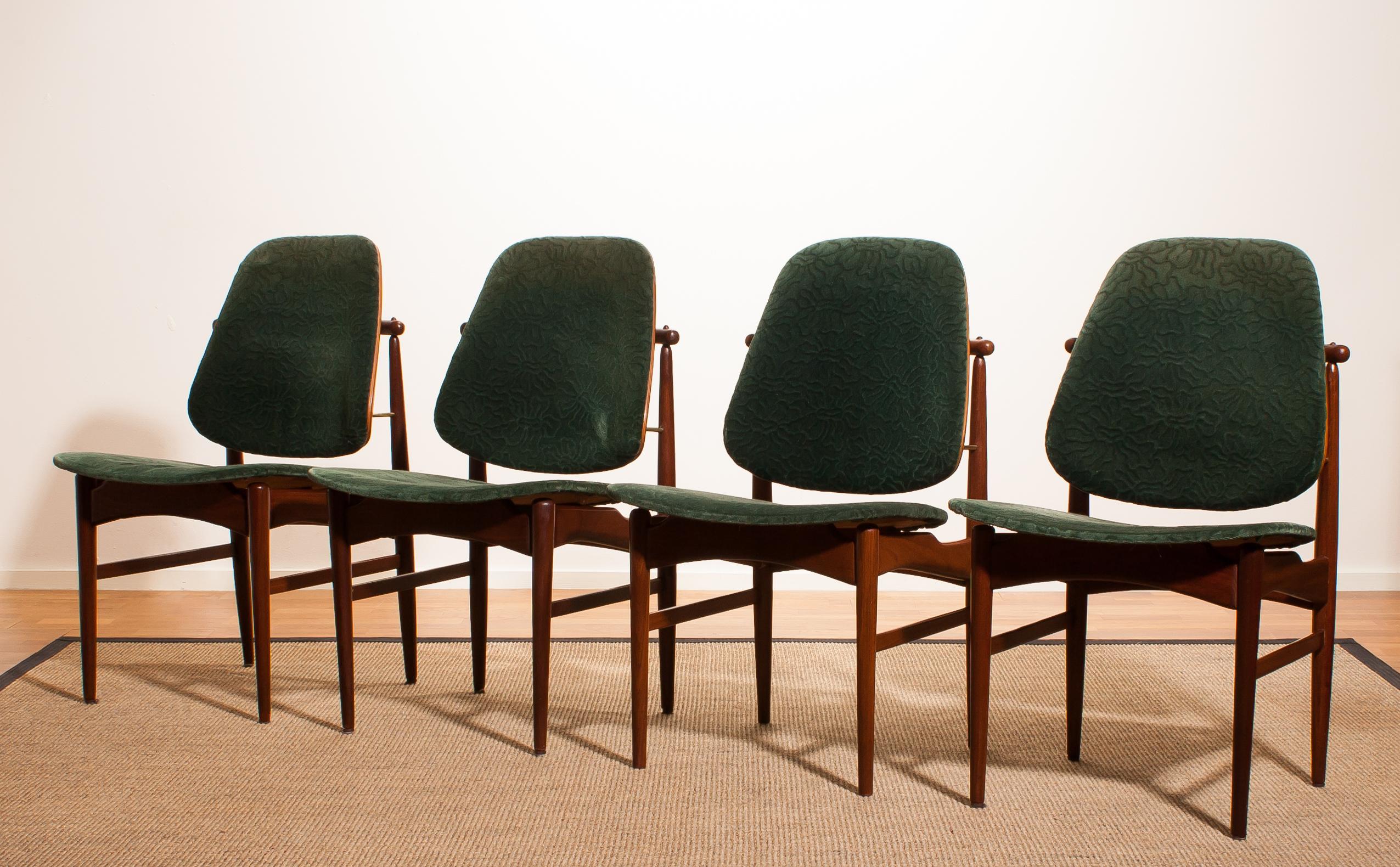 Beautiful set of four Arne Vodder design armchairs made by France & Daverkosen, Denmark. 
Seat and back covered in original bottle-green velvet fabric. 
These chairs sit extremely comfortable and are beautifully finished with beautiful bronze