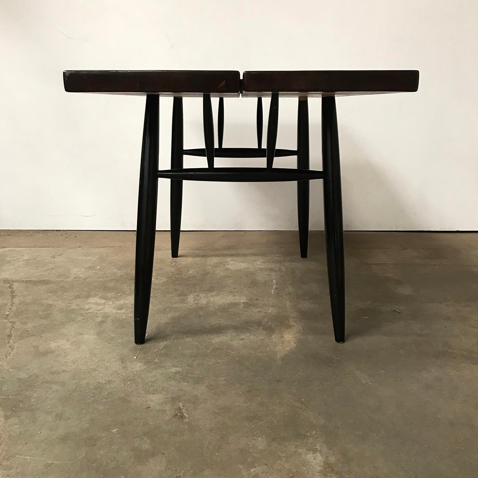 Pirkka table. The table has a beautiful wooden top. The table shows some traces of wear like a slightly lighter spot, a tiny damage of 5 mm and some loss of black paint of the legs. There is one leg with three red paints spots and 1 leg with a white