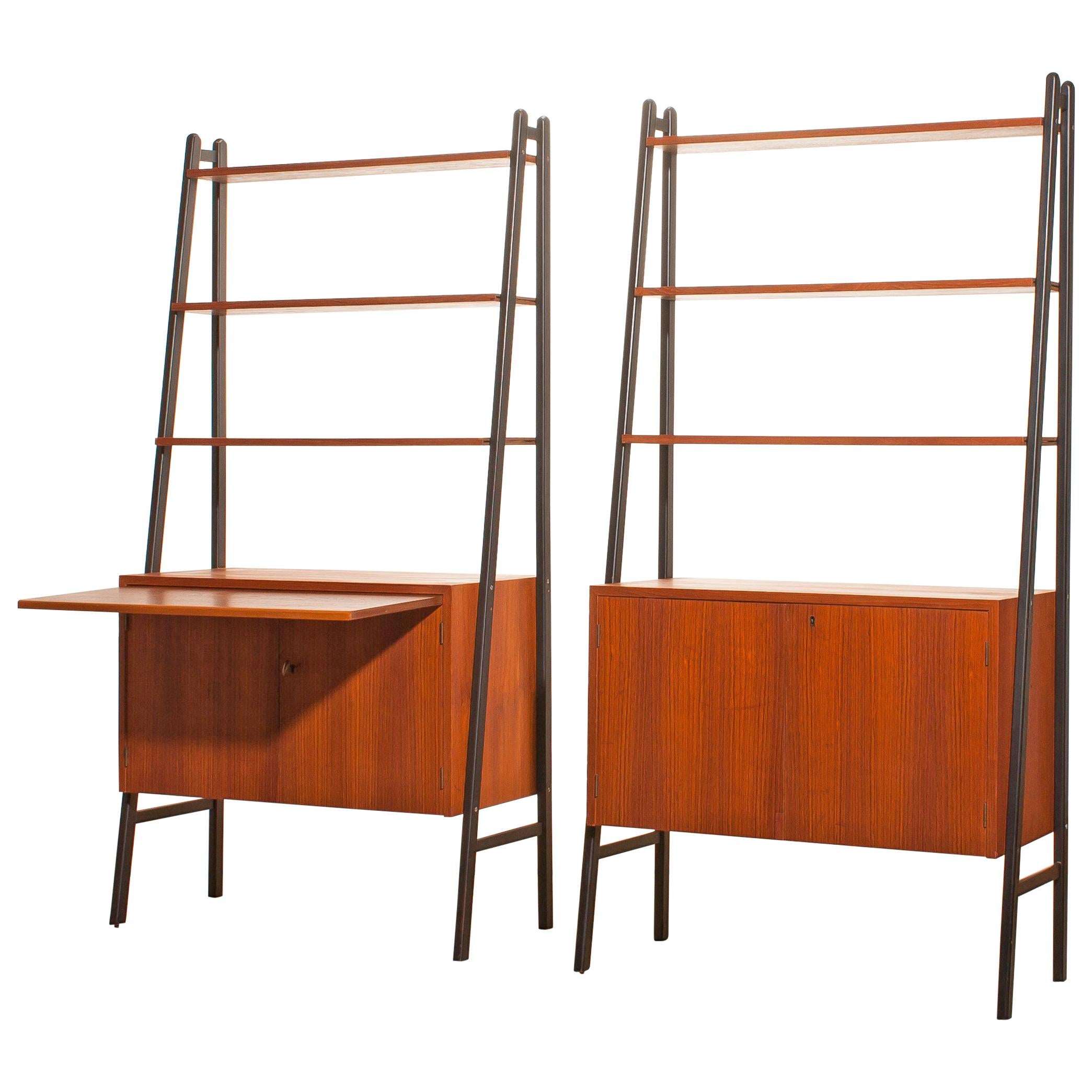 Two beautiful cabinets made of teak with black stands.
Because the cupboard is pretty slim and open to form it is also very suitable to use it as a room divider.
Each cabinet contains three shelves and a two-door cabinet.
One of the cabinets has