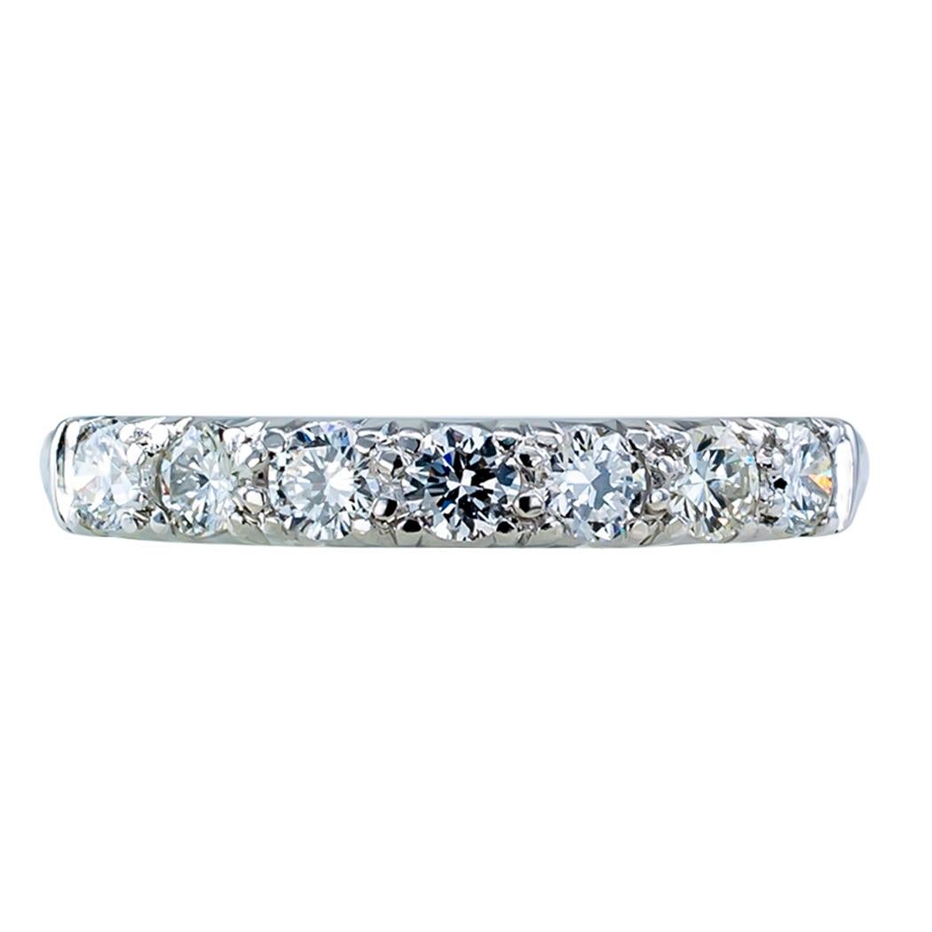 Seven stone diamond and platinum wedding band circa 1950. Featuring seven round brilliant-cut diamonds totaling approximately 0.50 carat, approximately G – H color and VS clarity, mounted in platinum. We love the classic design of this ring; the