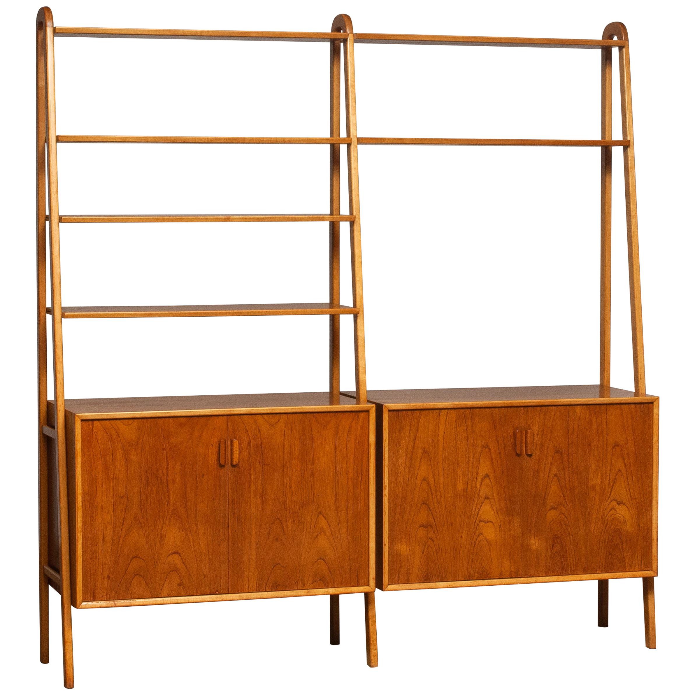 Beautiful and typical Swedish bookcase / shelfs cabinet in teak in combination with beech stands made by Brantorps, Sweden.
This cabinet consists six shelfs in which four are adjustable. The two on the top are fixed.
Two cabinets and also both