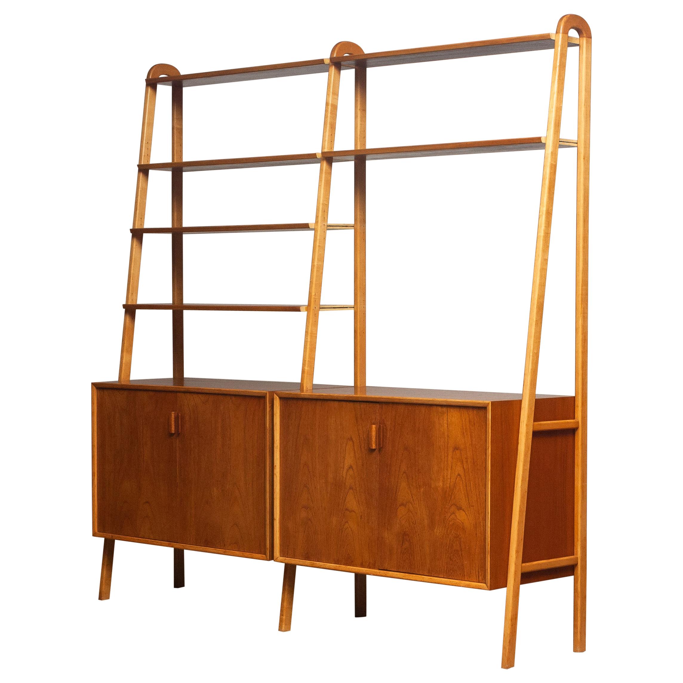 Beautiful and typical Swedish bookcase / shelfs cabinet in teak in combination with beech stands made by Brantorps, Sweden.
This cabinet consists six shelfs in which four are adjustable. The two on the top are fixed.
Two cabinets and also both