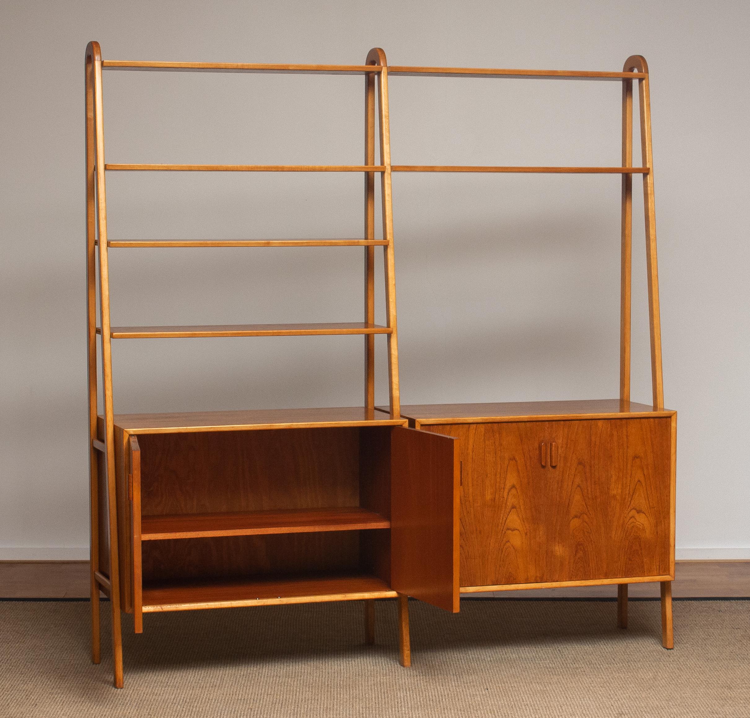 Beautiful and typical Swedish bookcase or shelfs cabinet in teak in combination with beech stands made by Brantorps, Sweden.
This cabinet consists six shelfs in which four are adjustable. The two on the top are fixed.
Two cabinets and also both