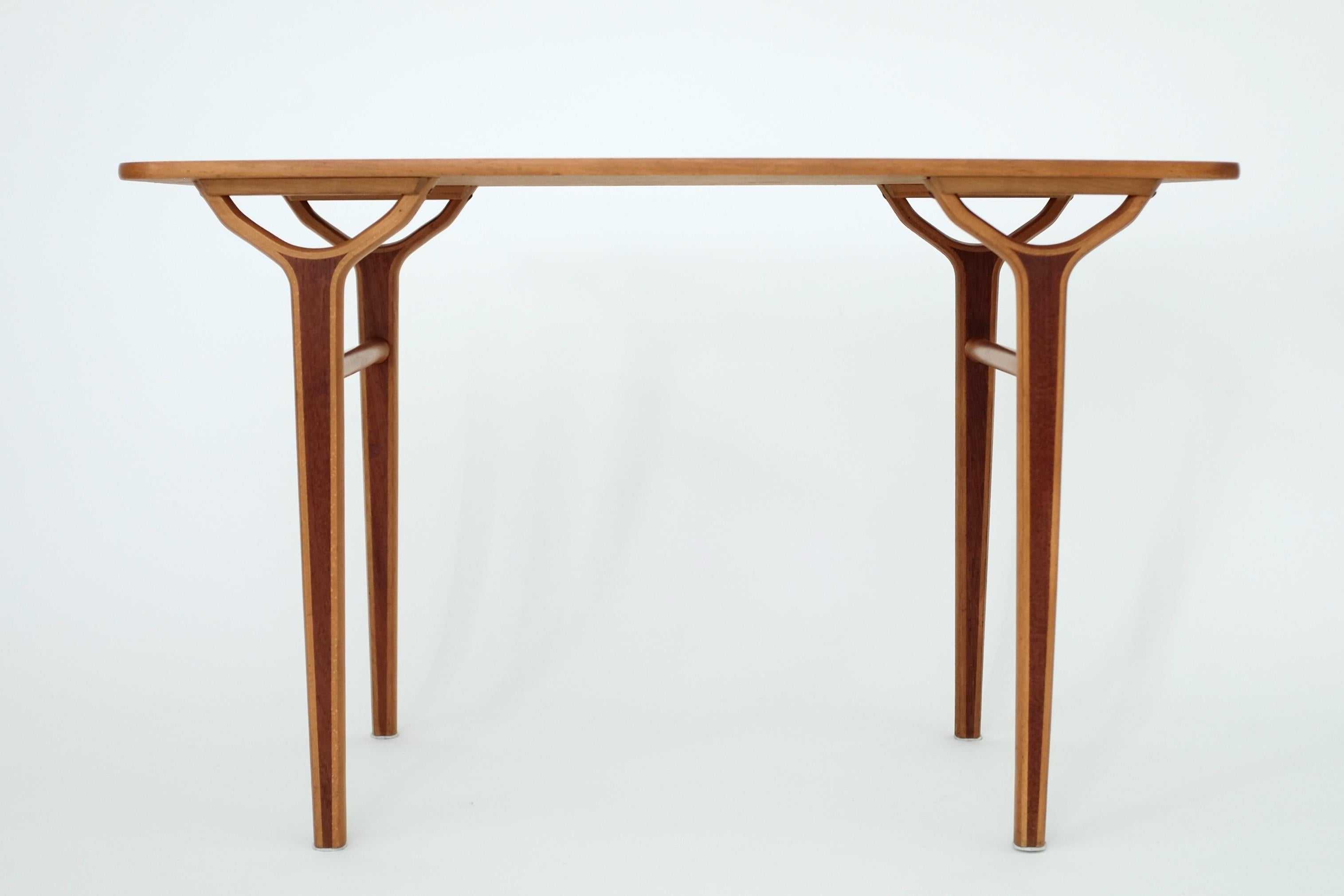 Beautiful and rare 1950's side table by Peter Hvidt & Orla Mølgaard-Nielsen for Fritz Hansen. It was part of the AX series designed by the two designers for FH and it contained tables and chairs. Inlays of teak on the legs creates a column like