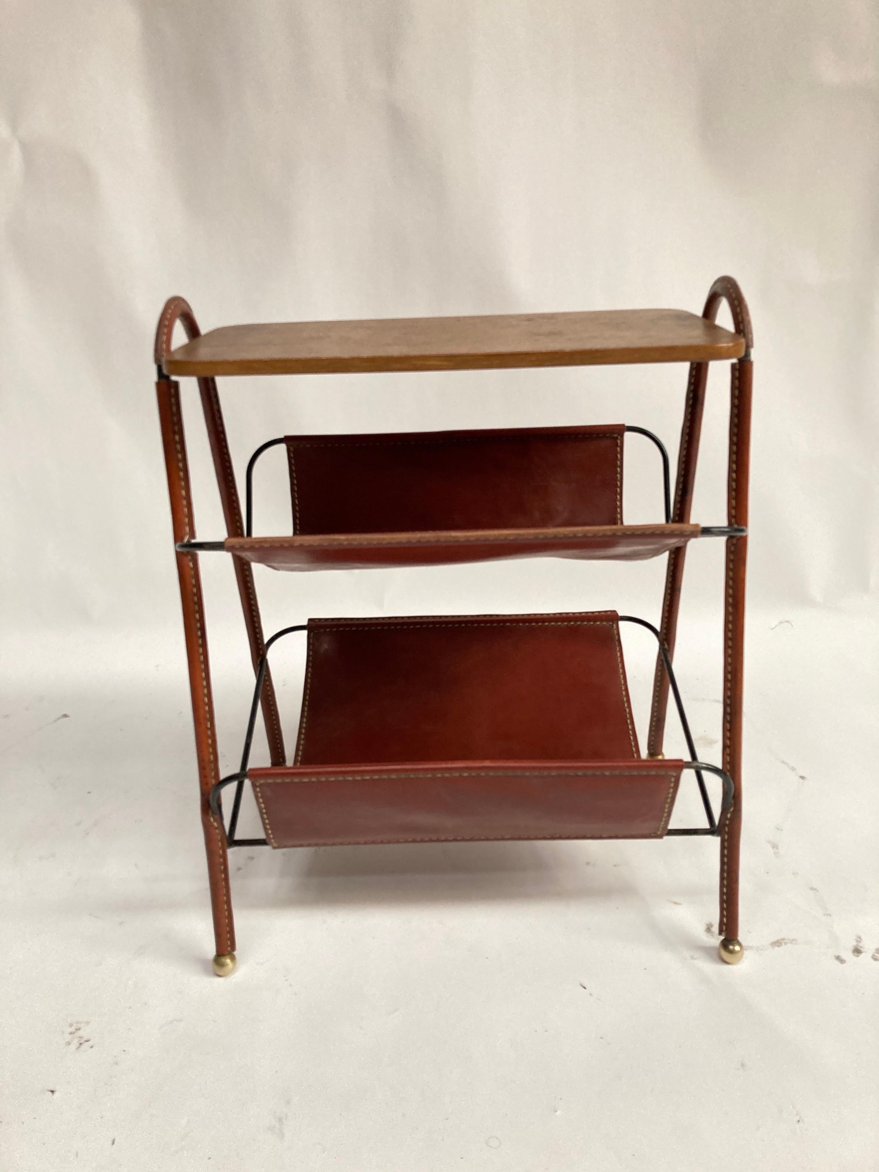 Very rare side table or double magazine rack 
Oak & stitched leather
France
1950's
By Jacques Adnet.