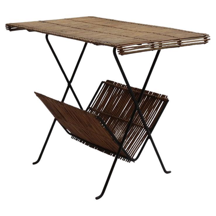 Merveilleuse table d'appoint de qualité des années 1950.  Fabriqué à partir d'une tige d'acier, qui a été formée en une merveilleuse forme sculpturale pour les pieds et le plateau cannelé, soutenu par un cadre en métal. Un porte-revues formé d'une