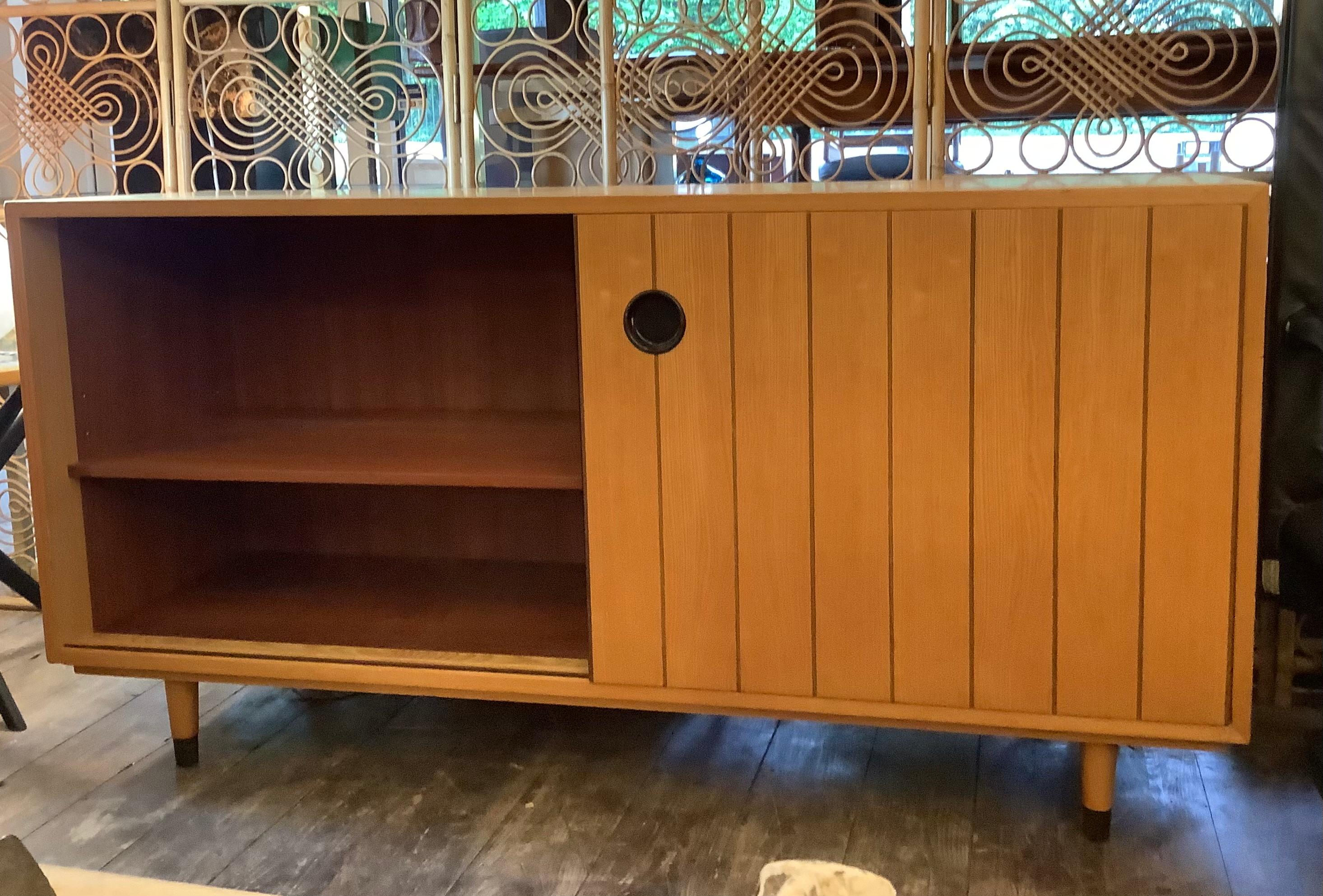 Beautiful vintage sideboard 1950s designed by Erich Stratmann for Oldenburg Mobelwerkstatten made of ash wood with black details  well maintained condition with age related sign of use .Shelve storage behind
sliding door. with 4 storage draws