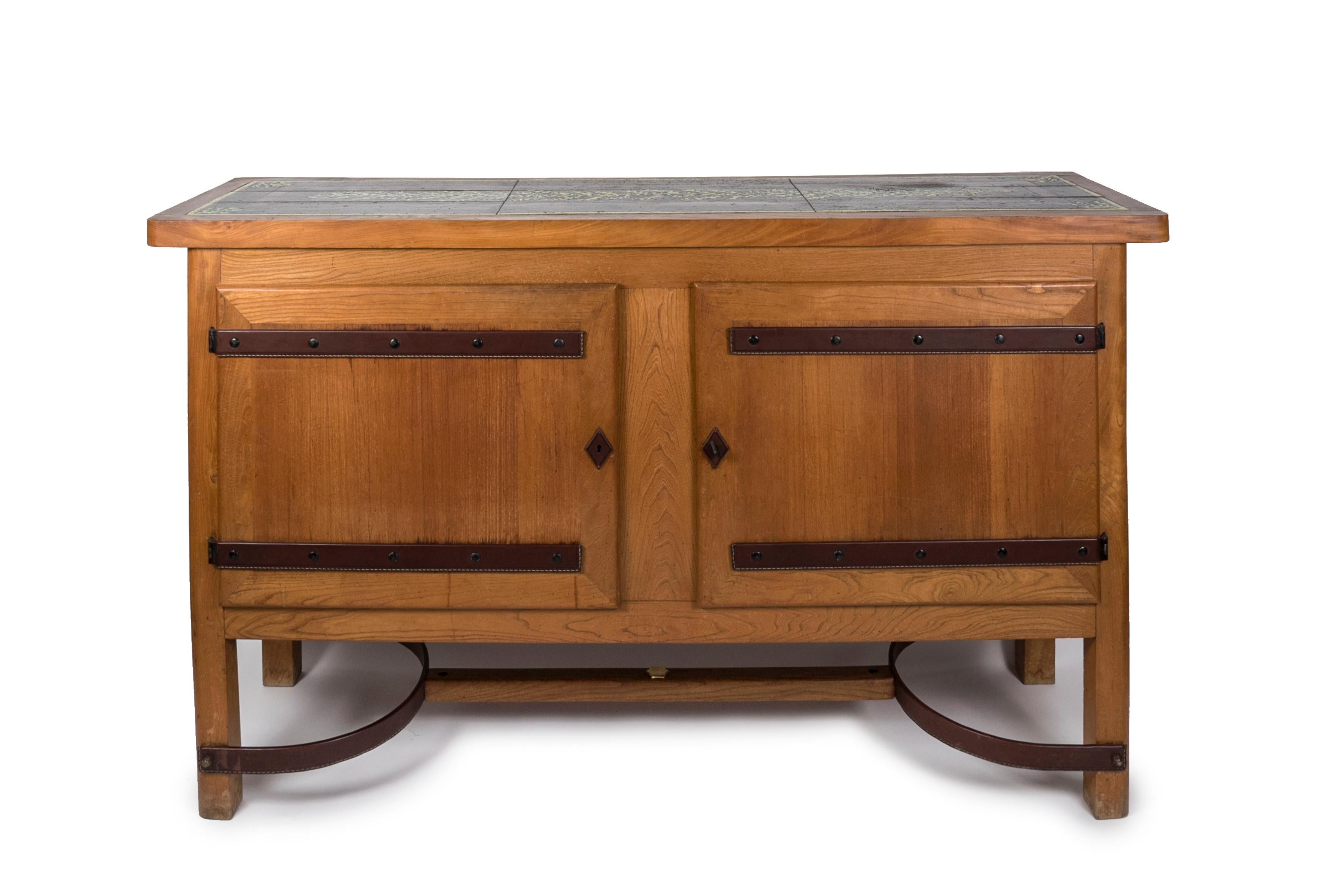 Rare sideboard with ceramic top
Oak and stitched leather part 
Good vintage condition
France.