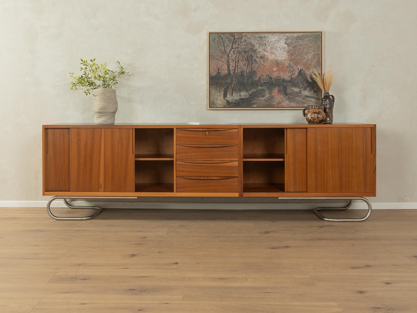 Unique semi solid sideboard in Scandinavian style from the 1950s. Corpus in walnut veneer with four sliding doors, two shelf, four drawers and new stainless steel feet in Bauhaus design. The top is coated with black Formica.

Quality