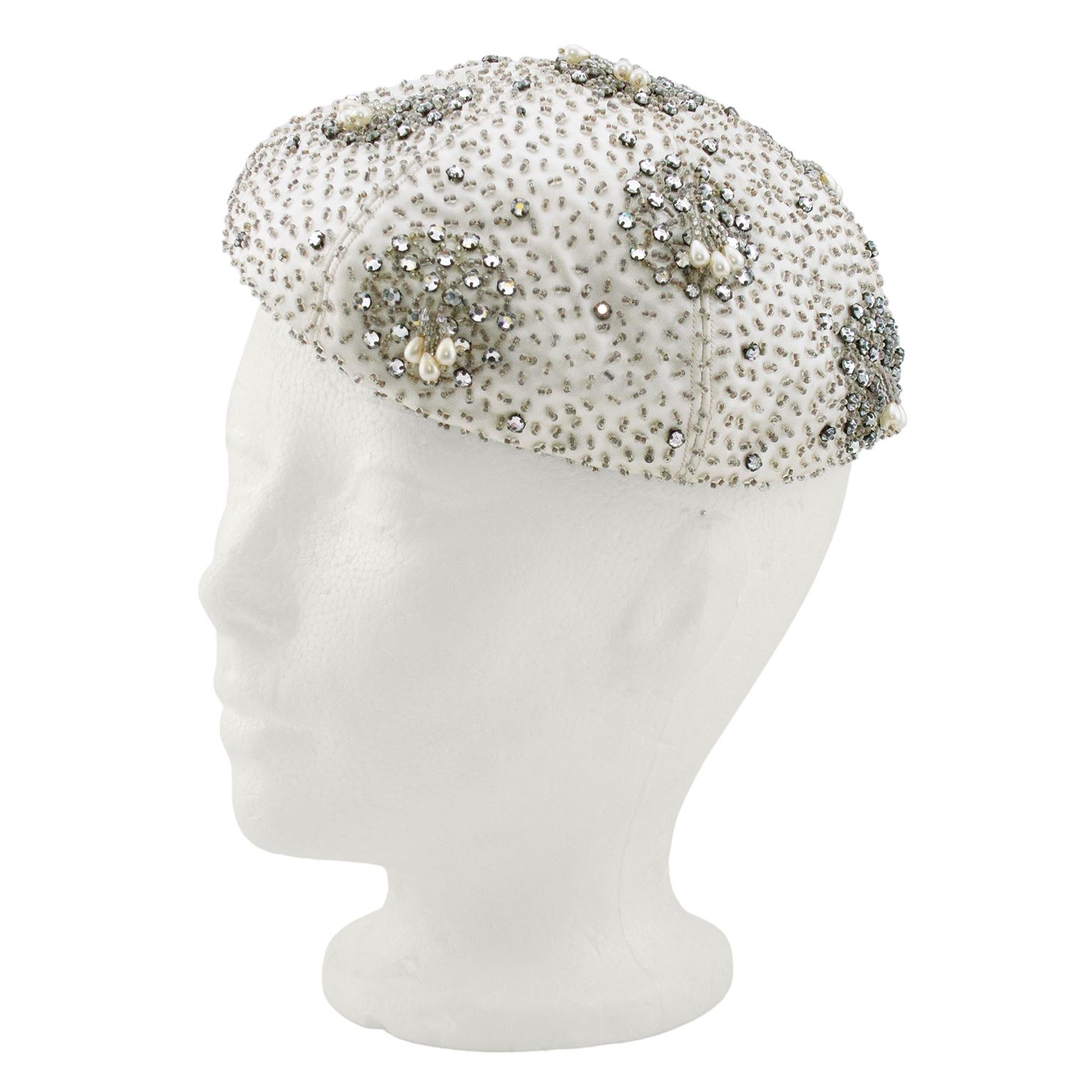 Fabulous 1950s silver beret. Embellished off-white satin fabric  with small clear beads and silver rhinestones. Small beaded tassels with teardrop shaped pearls. Contrasting interior magenta grosgrain ribbon. 22.5