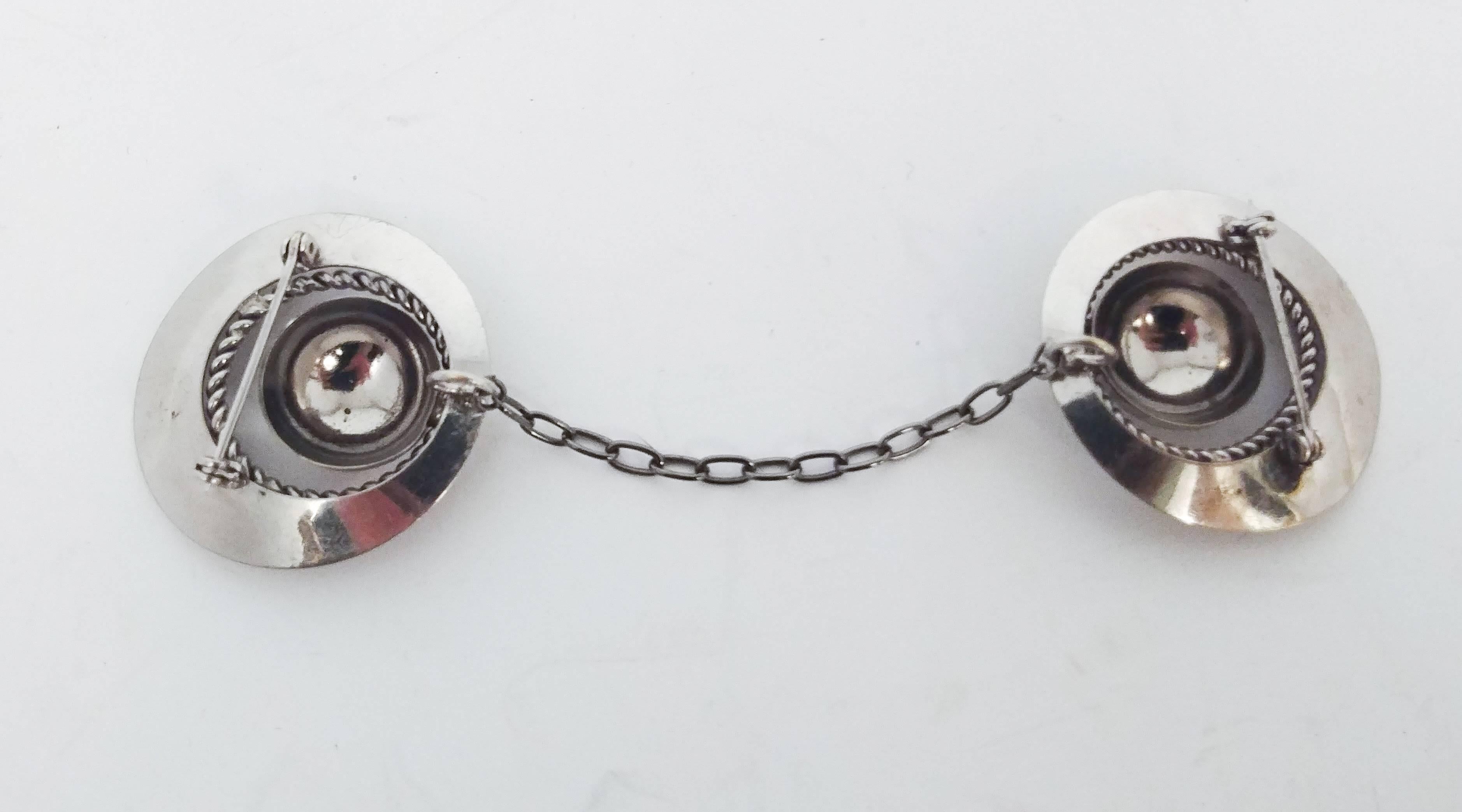 1950s Silver Circles Sweater Guard. Circular concentric clips pin onto either side of shirt or sweater collar, attached with a chain. 