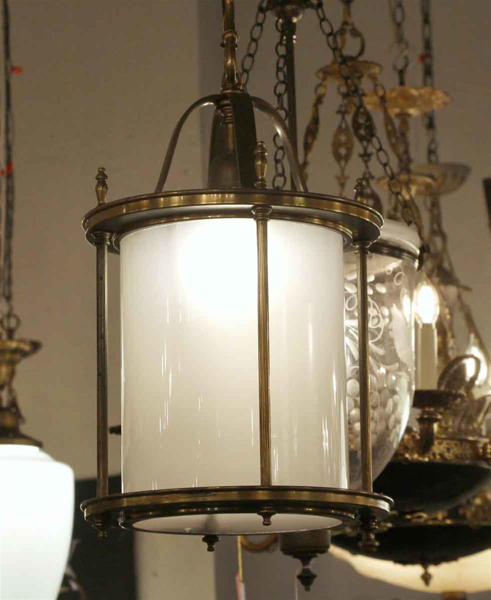 1950s single bulb lantern made of brass and white milk glass. Cleaned and rewired. Small quantity available at time of posting. Please inquire. Priced each. Please note, this item is located in one of our NYC locations.