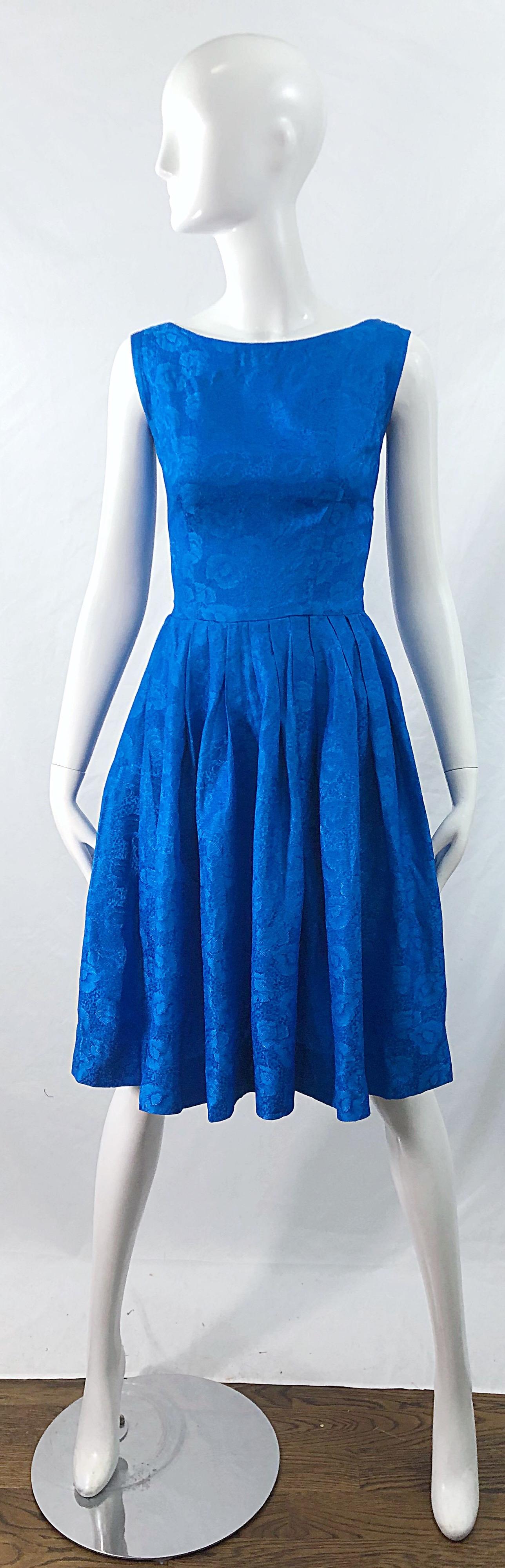 Beautiful 1950s Size 0 cobalt blue silk damask fit n' flare sleeveless rockabilly dress ! Features a tailored bodice with a full skirt. Full metal zipper up the back with hook-and-eye closure. Plenty of room in the skirt to wear a crinoline