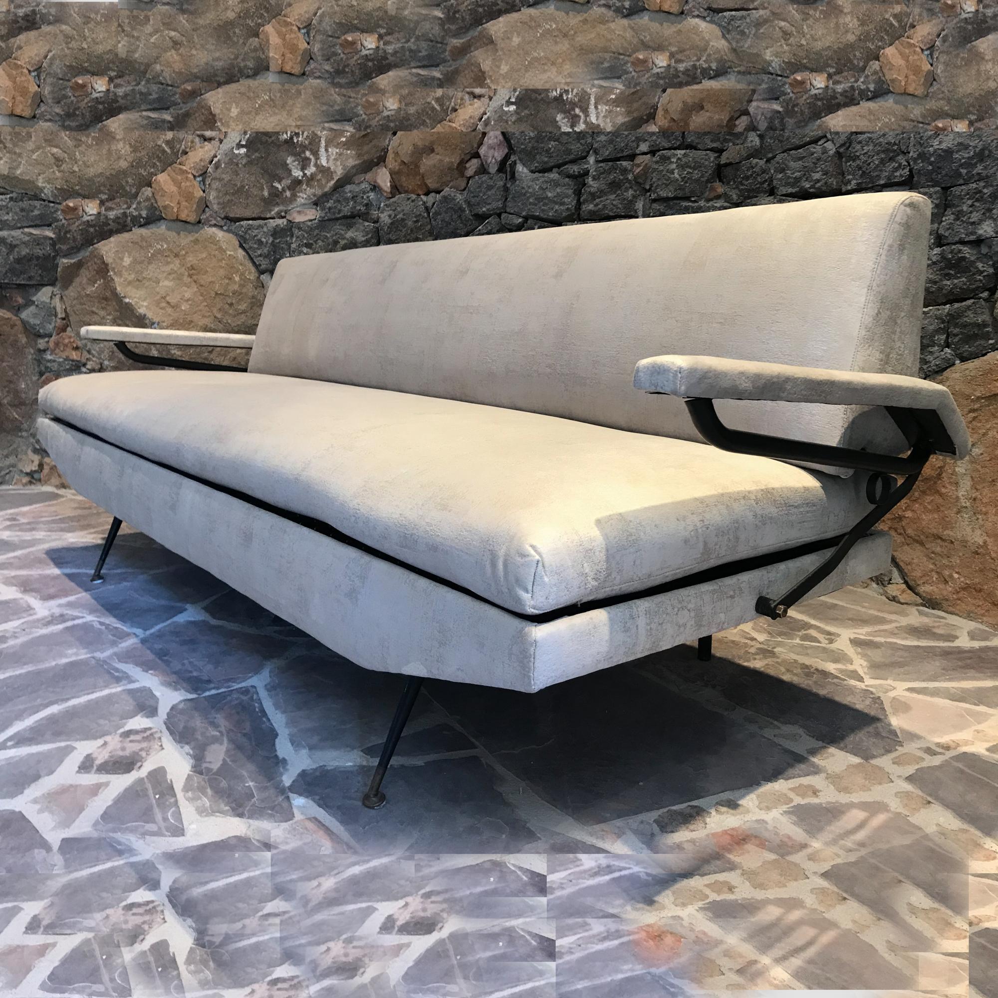 Italian Sofa-Day Bed in the manner of architect designer Osvaldo Borsani.
Iron and Wood.
Unmarked.
Made in Italy 1950s. 
Arms can be lifted providing more room for lounging and afternoon siesta. 
Daybed has adjustments underneath the cushions that